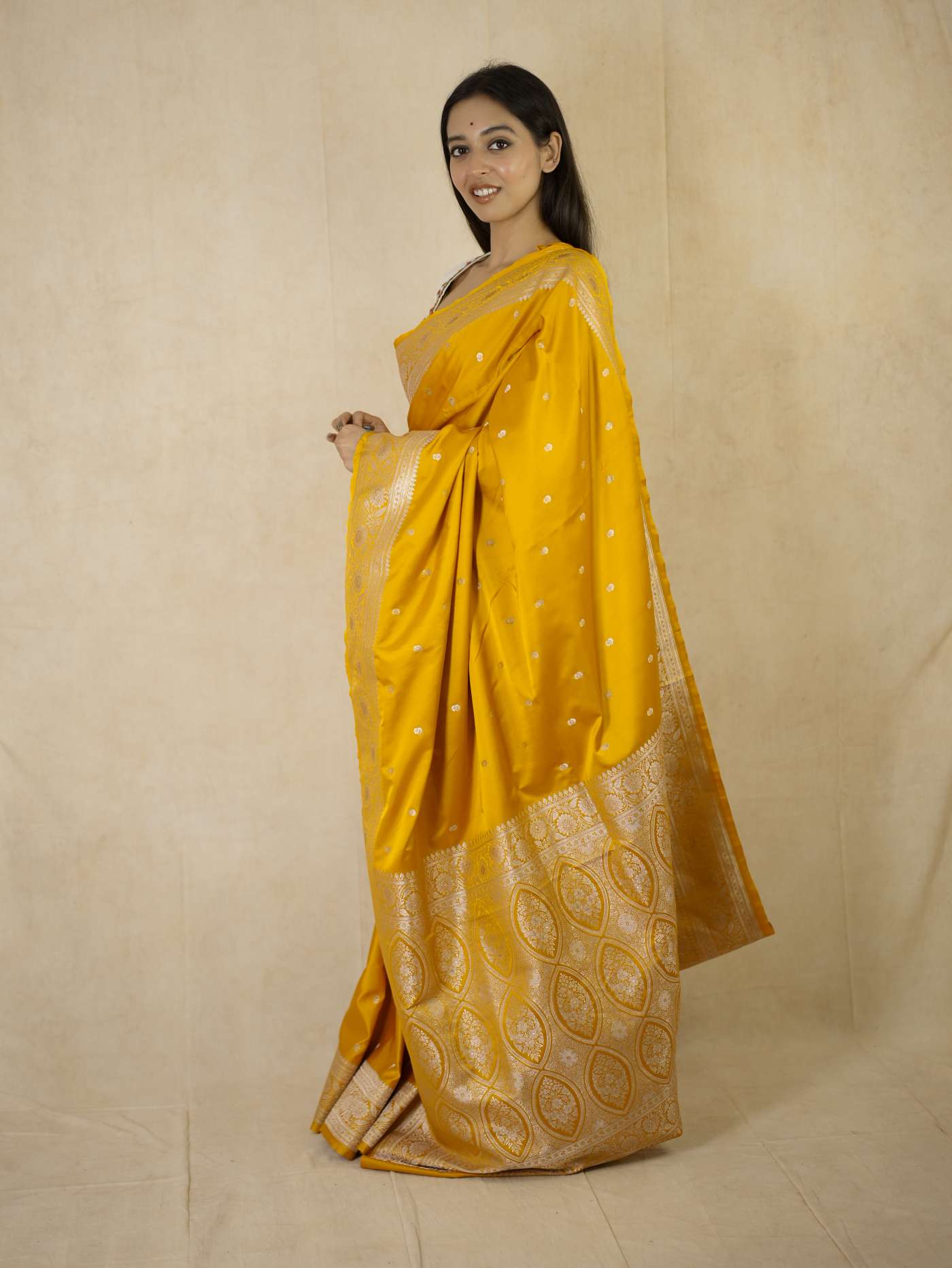 Yellow semi Benarasi silk saree with intricate designs and matching blouse piece from Joyee Kolkata, traditional Indian attire.