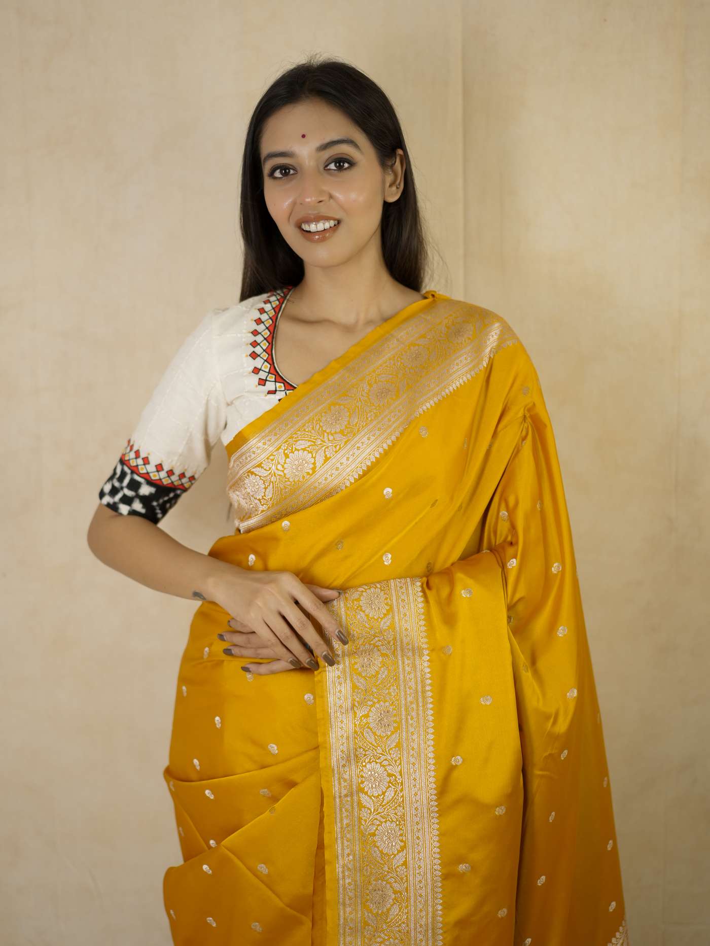 Yellow semi Benarasi silk saree with intricate patterns and matching blouse piece by Joyee Kolkata.