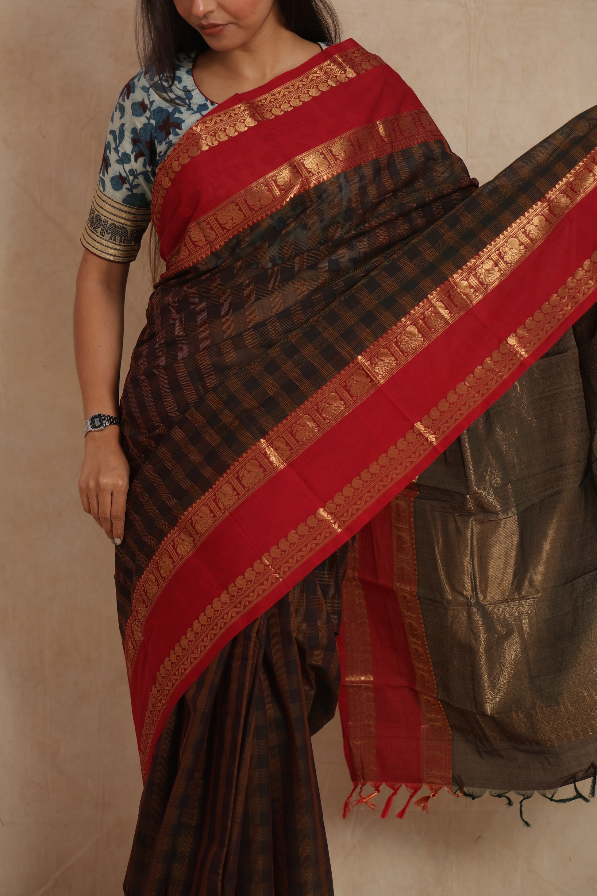 Close-up of red zari border with traditional motifs on Kanchipuram cotton saree