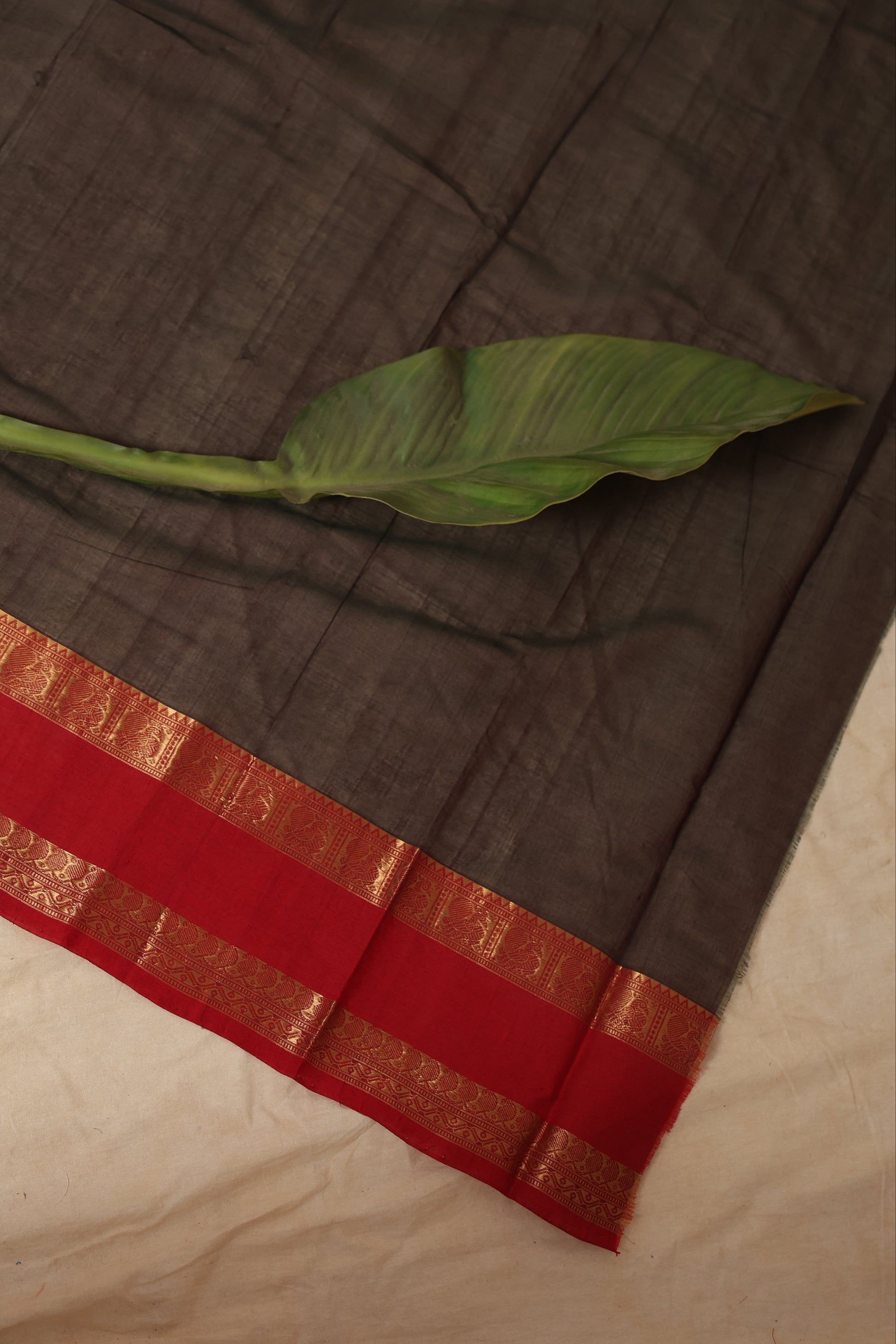 Fabric texture of Kanchipuram cotton saree with brown body and red border
