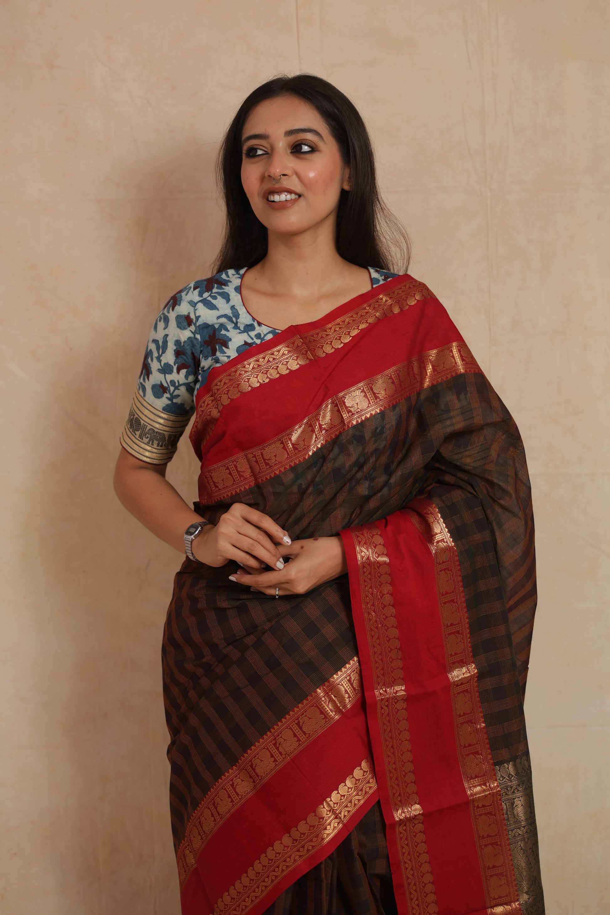 Portrait of model wearing Kanchipuram cotton saree with bold red border