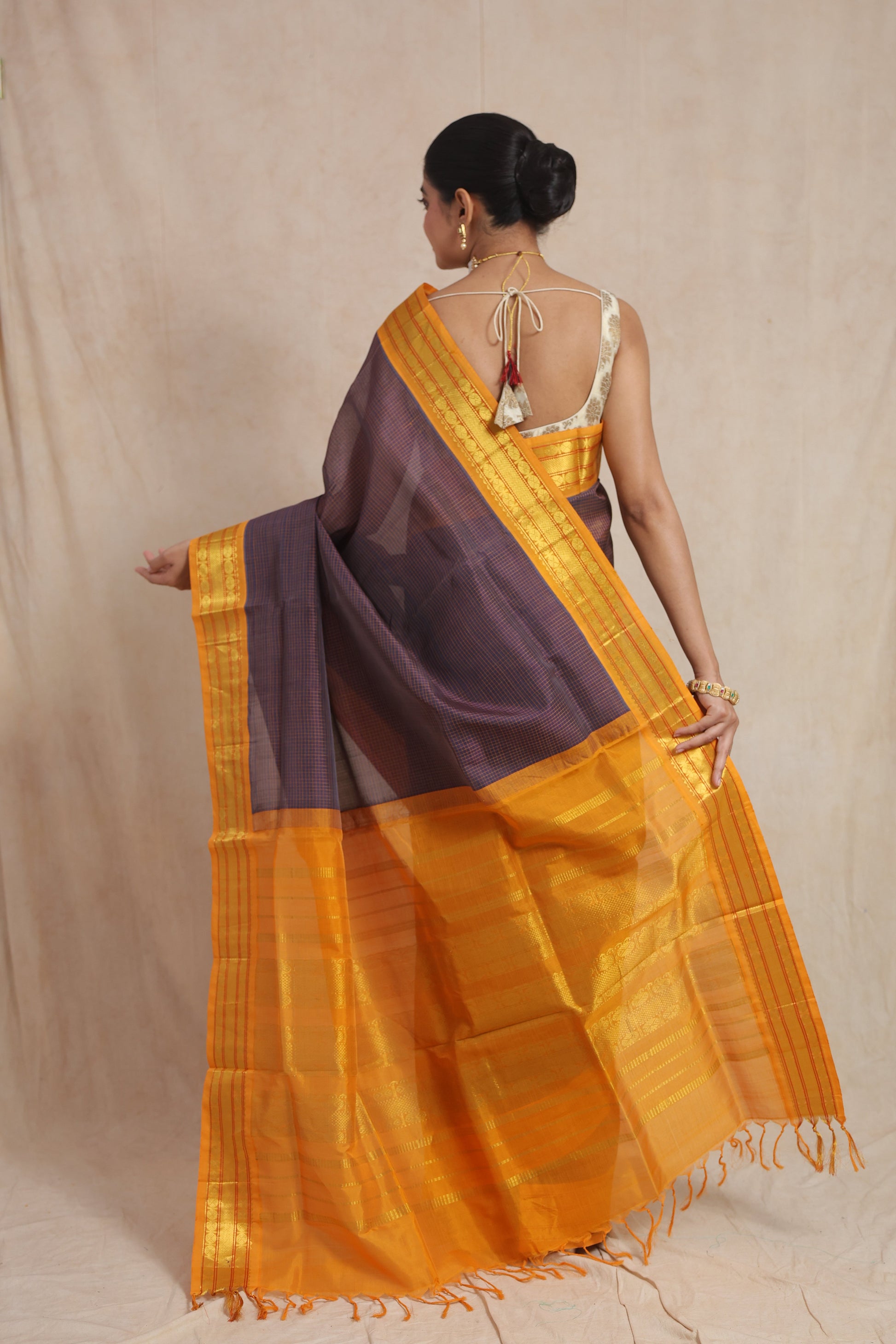 Back view of indigo Kanchipuram Sico saree with rich mustard zari pallu