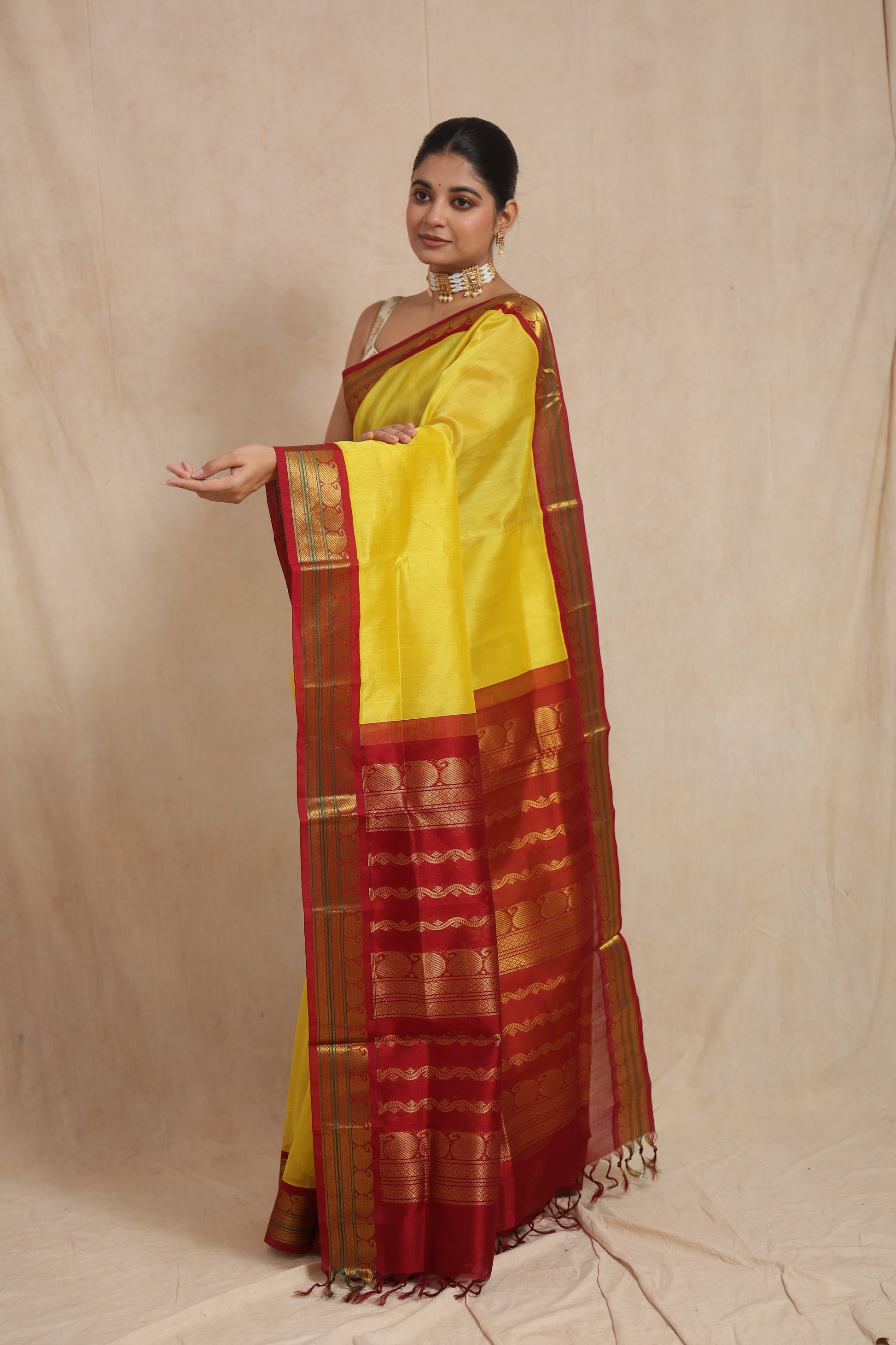 Detailed pallu view of yellow Kanchipuram Sico saree with zari weaving
