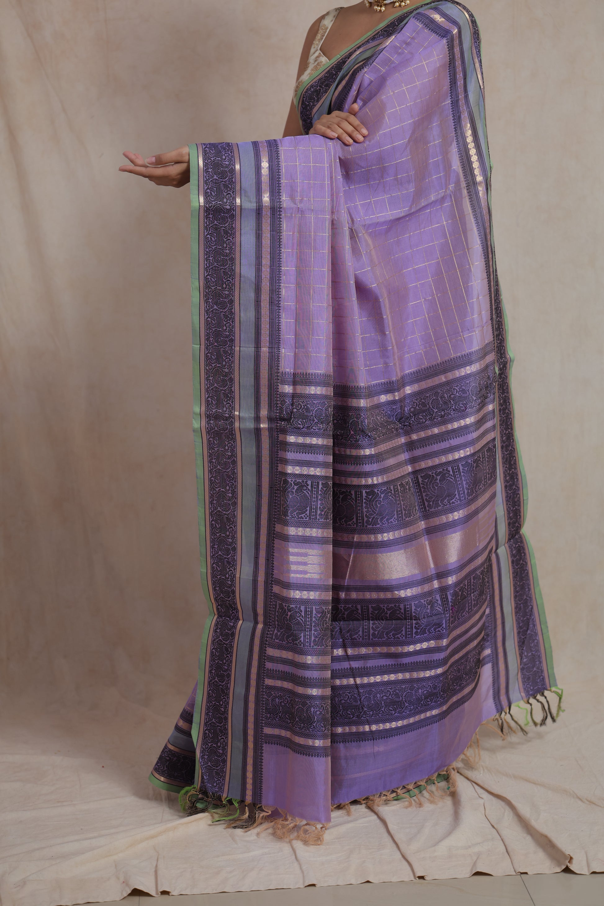 Closeup of lavender Kanchipuram silk cotton saree with traditional woven border