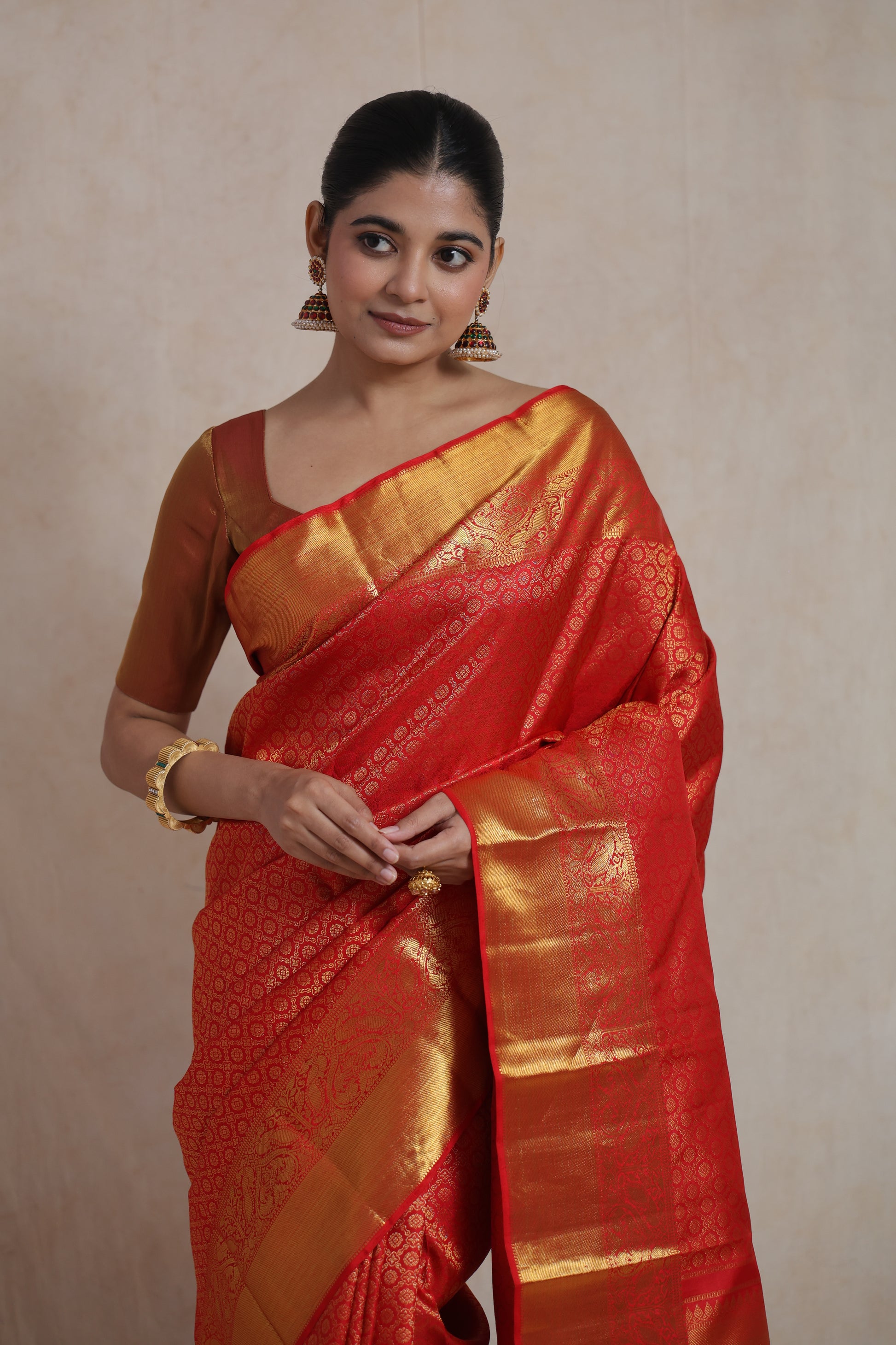 Model wearing red Kanchipuram saree with classic styling