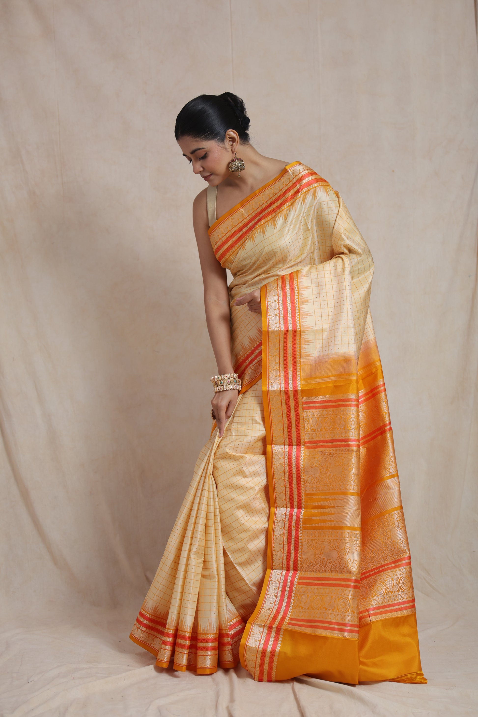 Back view highlighting grand zari pallu with traditional motifs