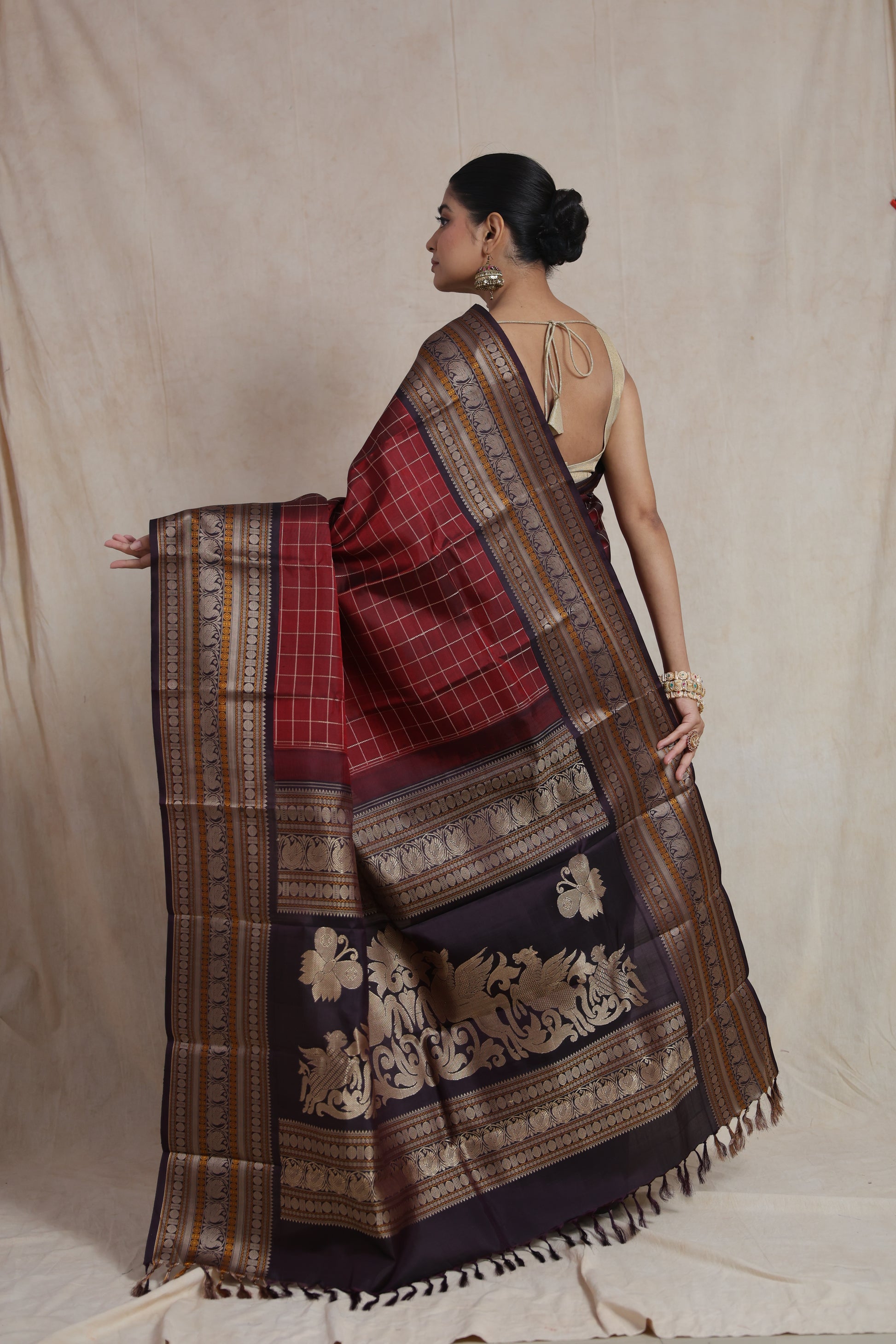 Back view of deep wine Kanjeevaram silk saree showcasing luxurious woven pallu