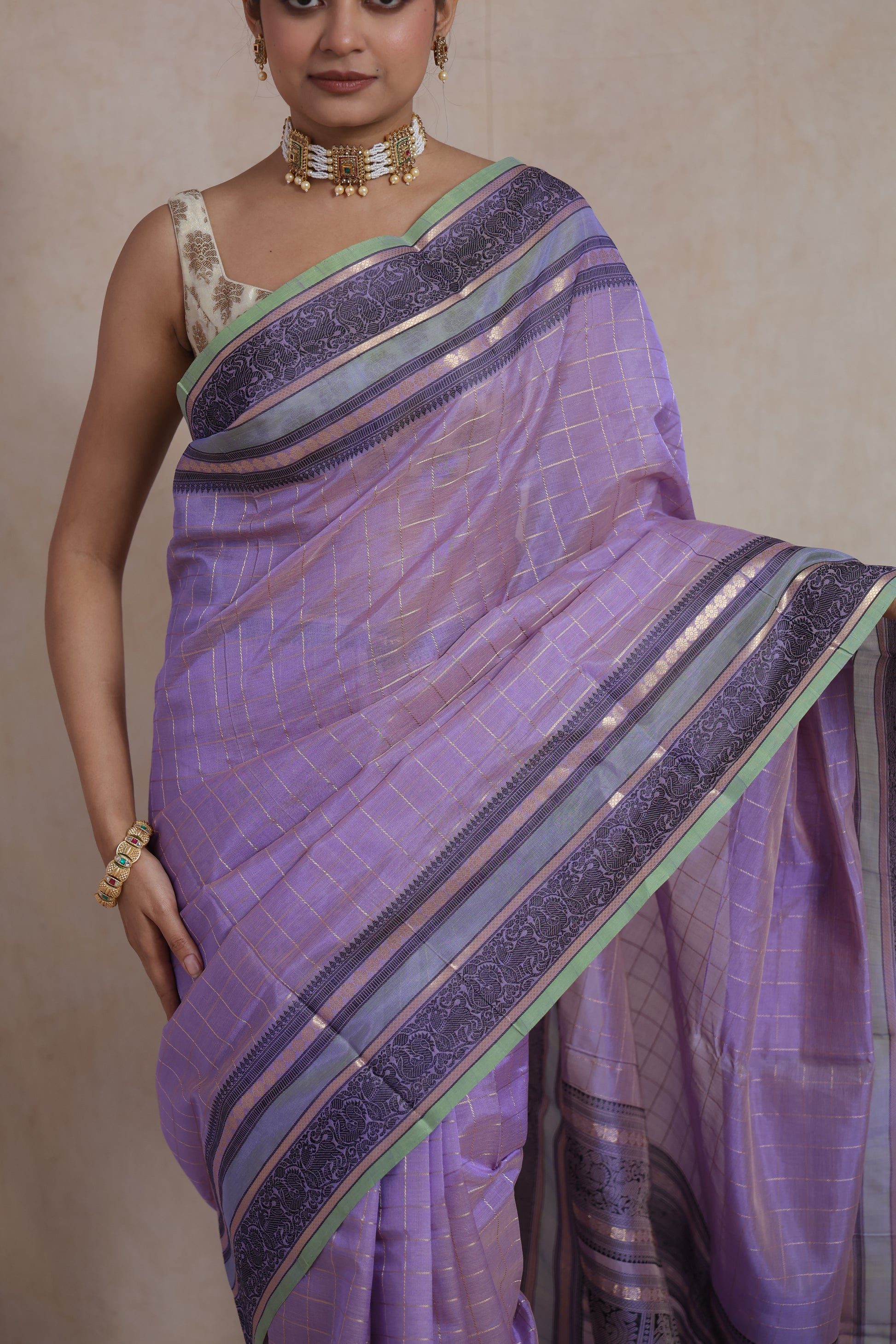 Closeup drape view of lavender Kanchipuram silk cotton saree with zari border