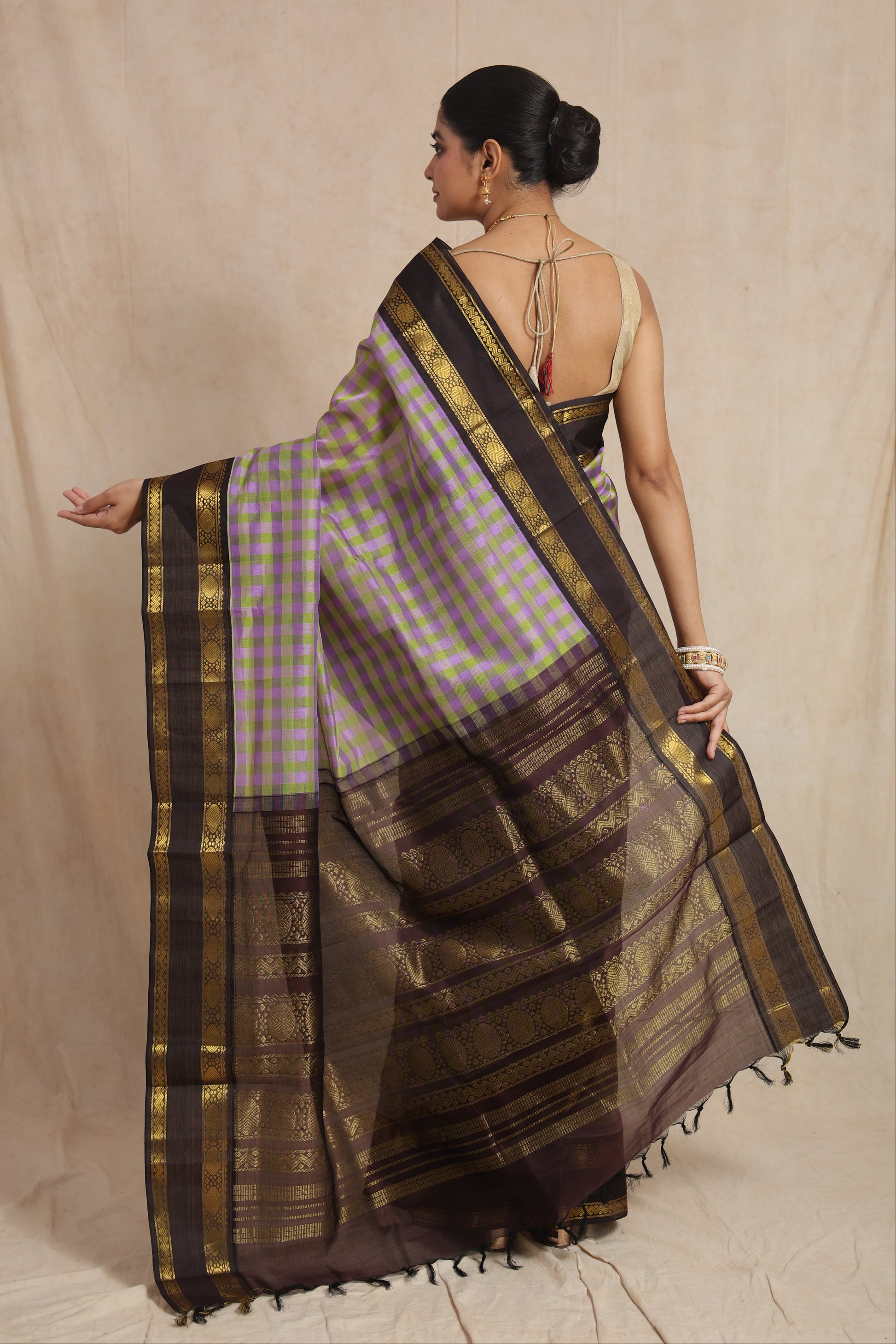 Back view of lavender and olive green checked Kanchipuram Sico saree with black zari pallu