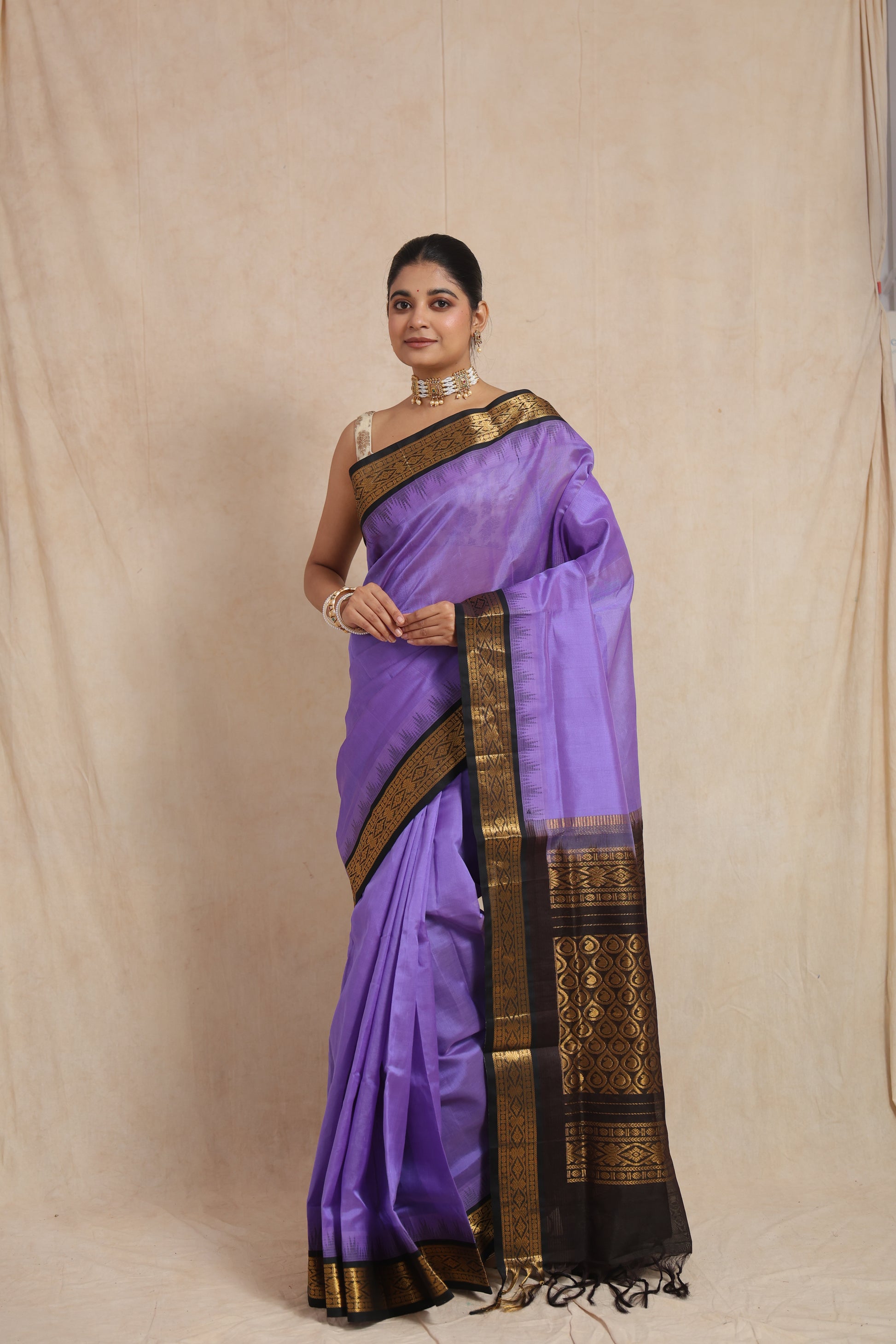 Portrait view of lavender purple Kanchipuram Sico saree with traditional zari detailing