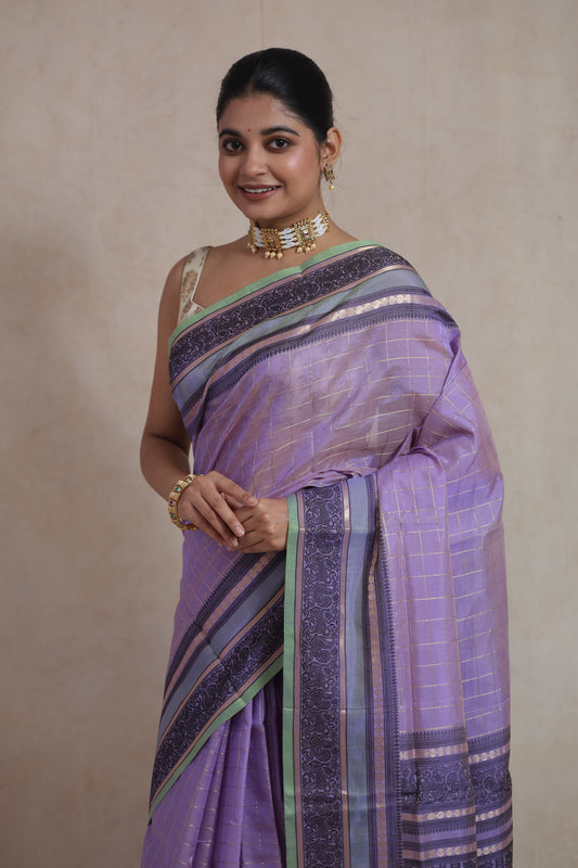 Model wearing lavender Kanchipuram silk cotton saree with zari checks