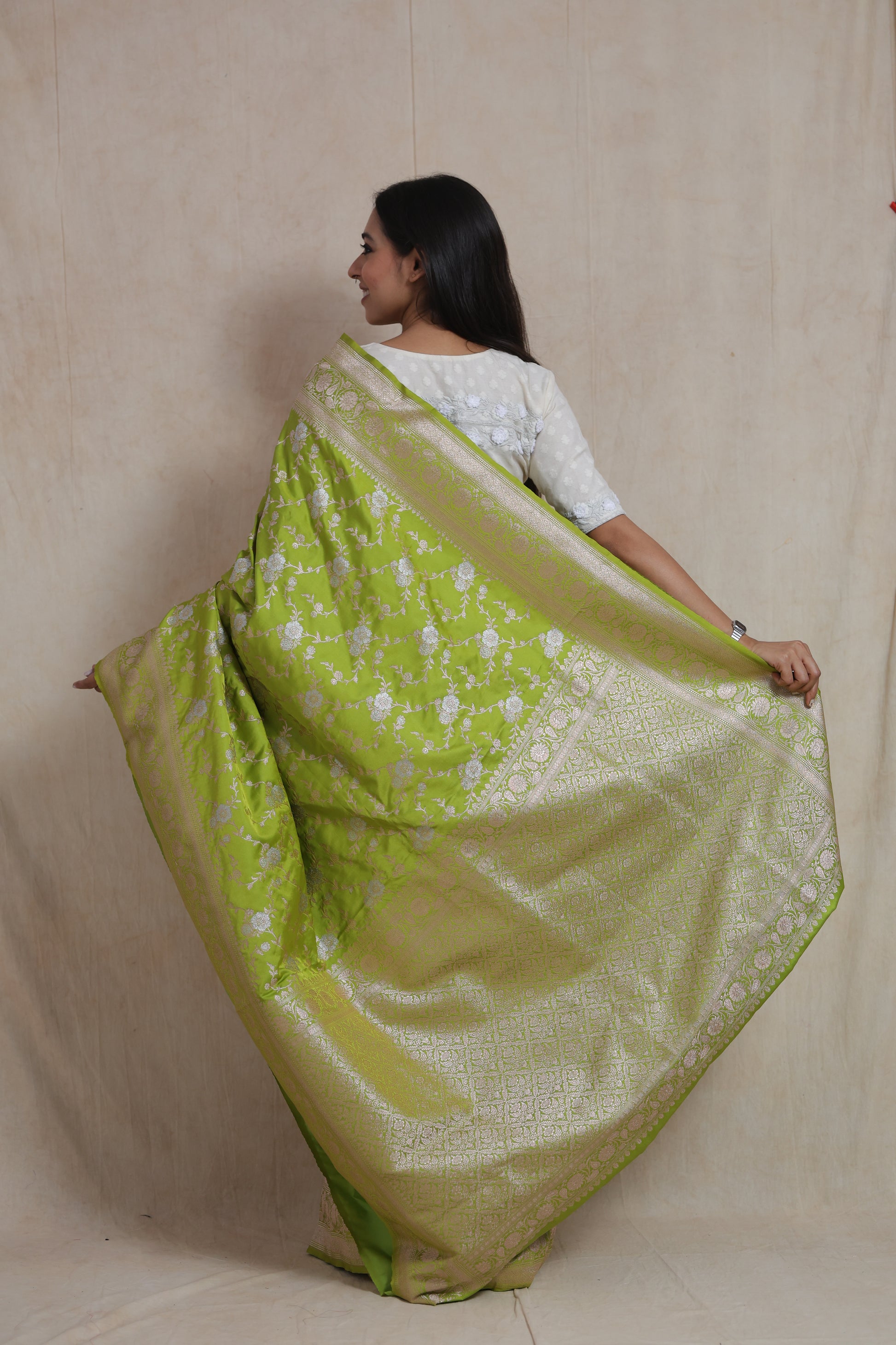Back view of lime green Banarasi art silk saree showcasing richly woven pallu and border