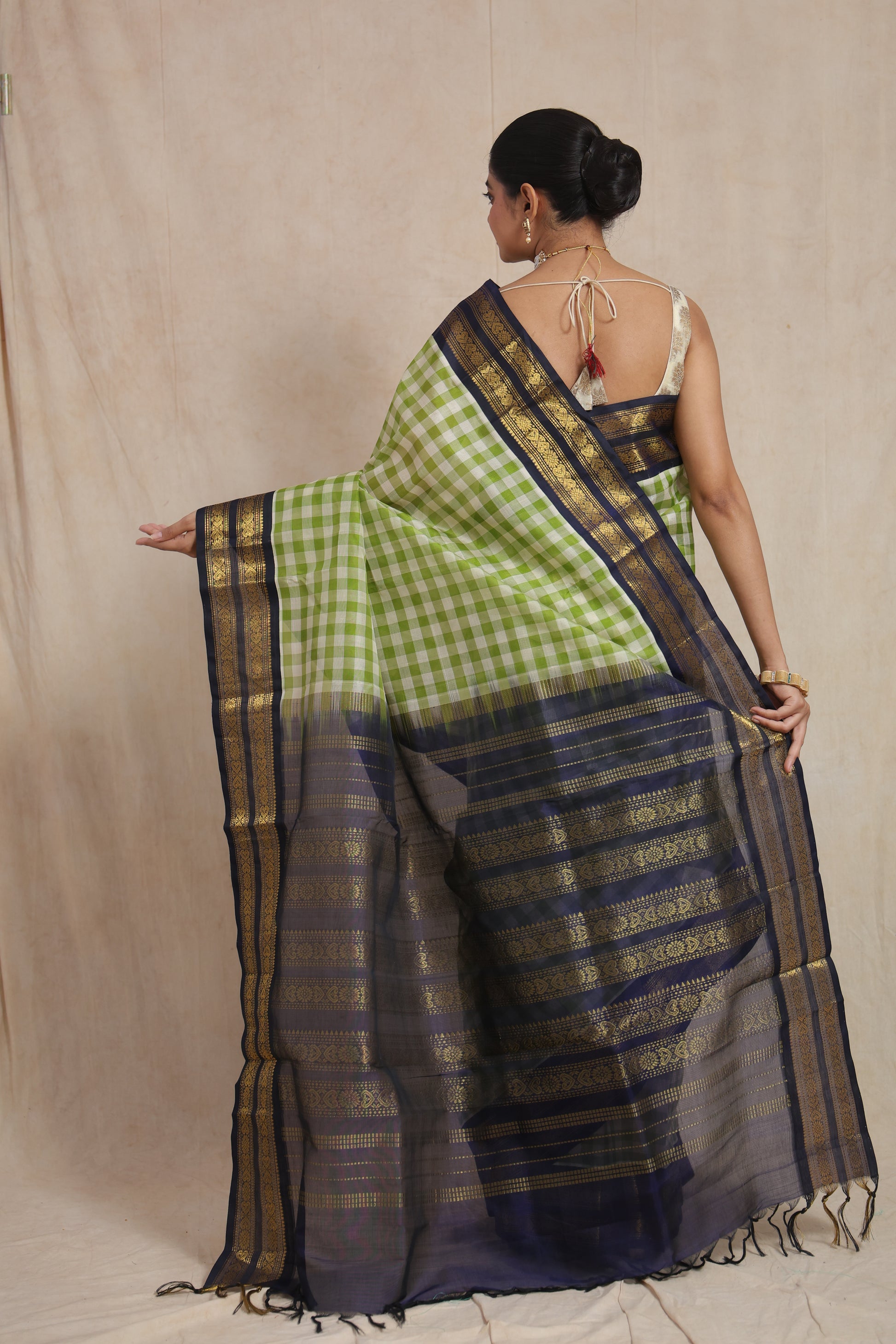 Back view of lime green checked Kanchipuram Sico saree with navy blue woven pallu