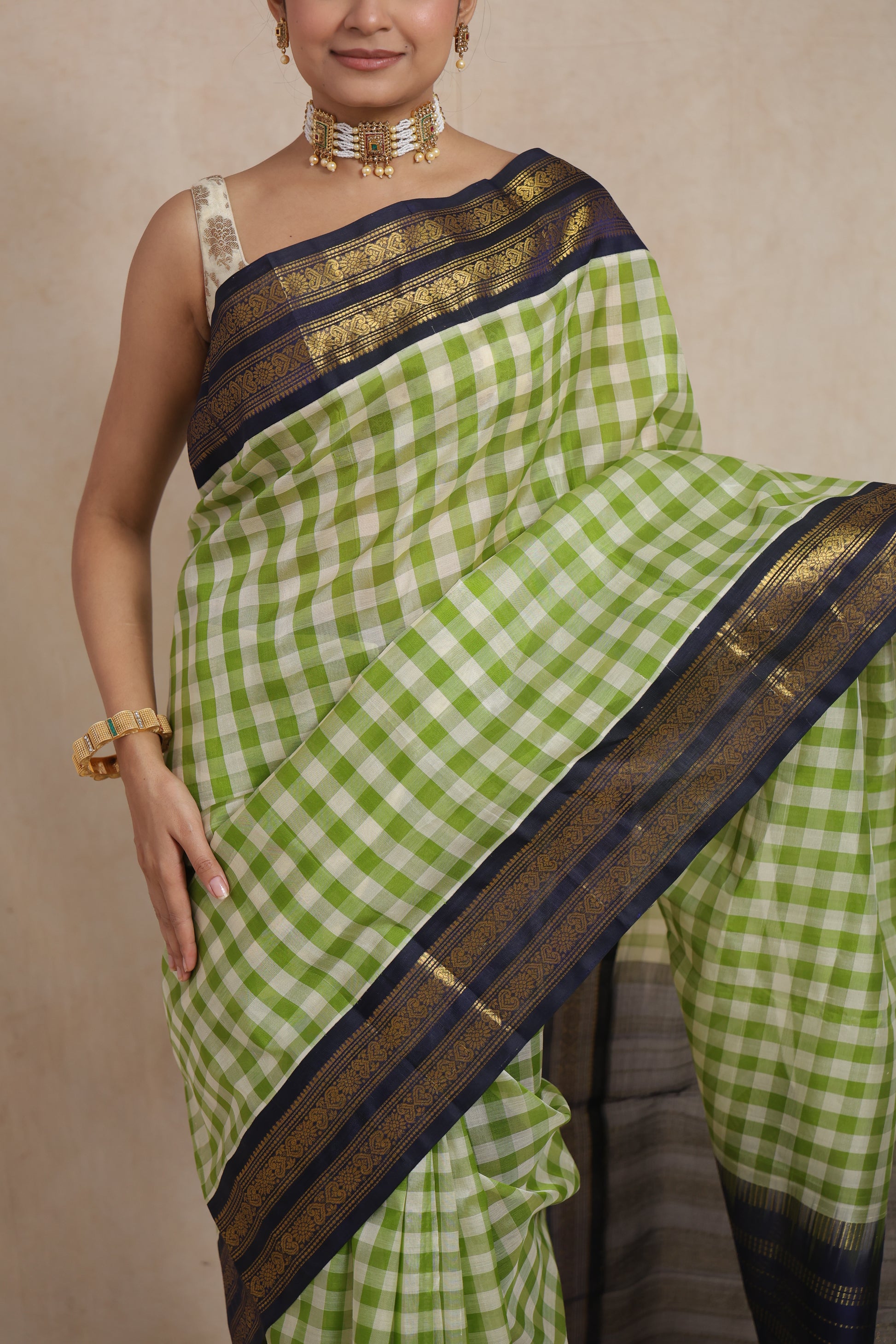Close-up of lime green and ivory checked Kanchipuram Sico saree with zari woven border