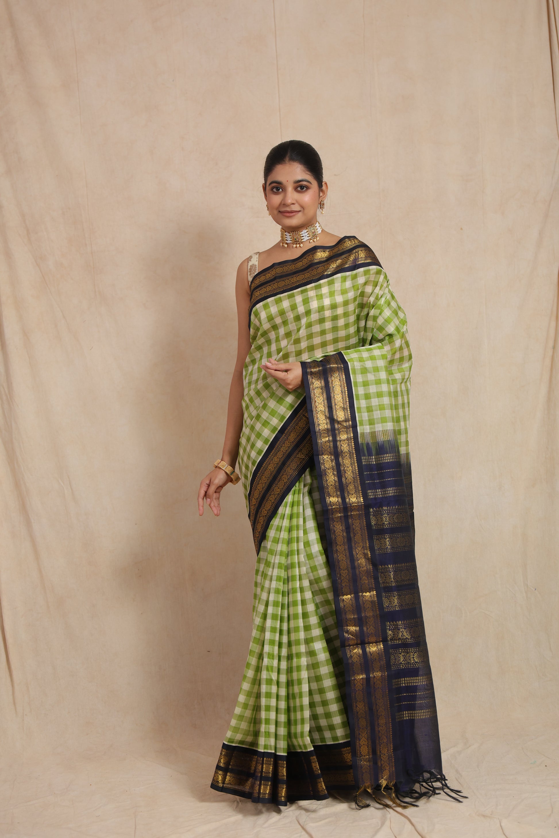 Front look of handwoven lime green checked Kanchipuram Sico saree with traditional woven detailing