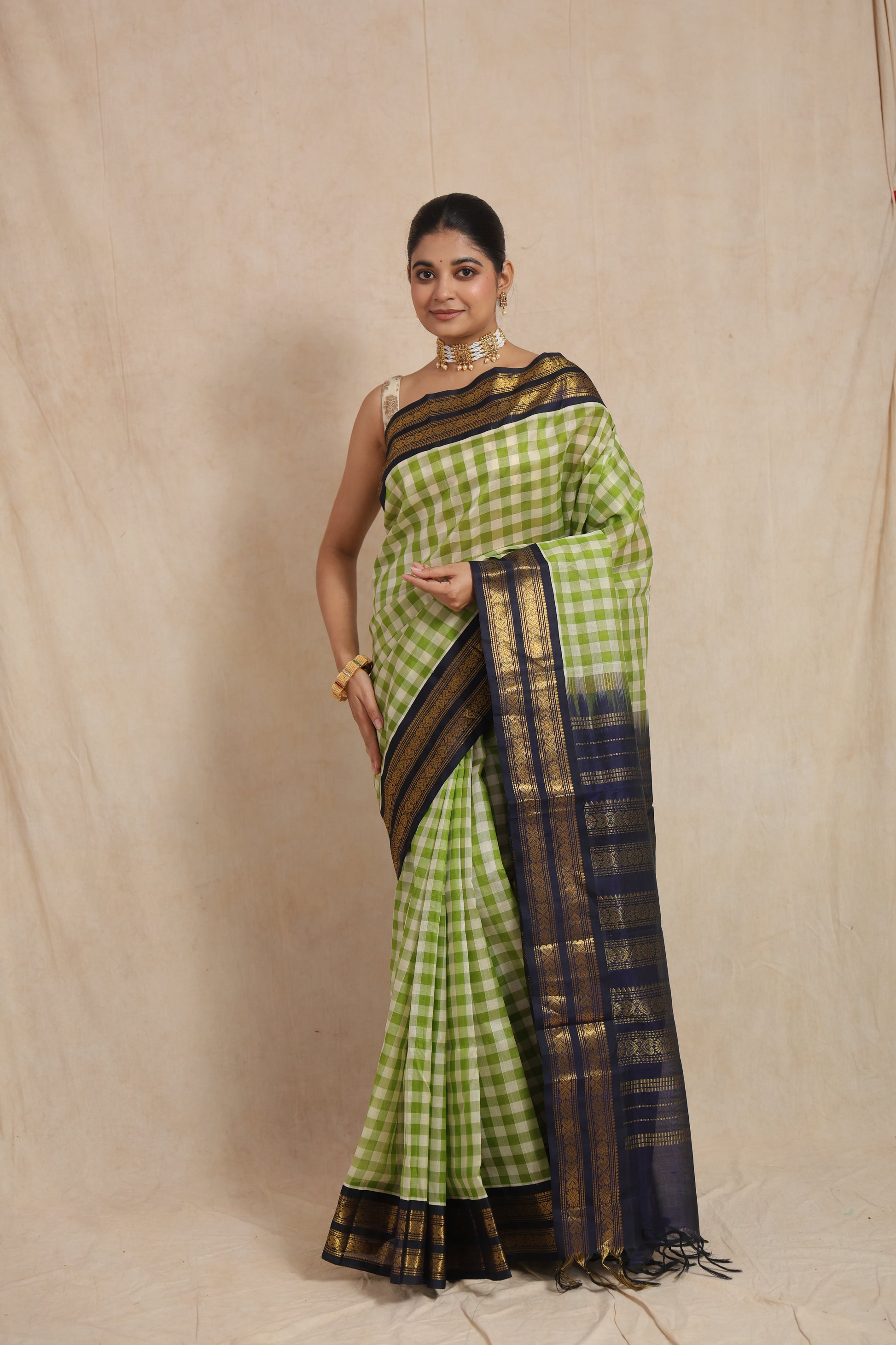 Full drape view of lime green checked Kanchipuram Sico saree with rich woven pallu