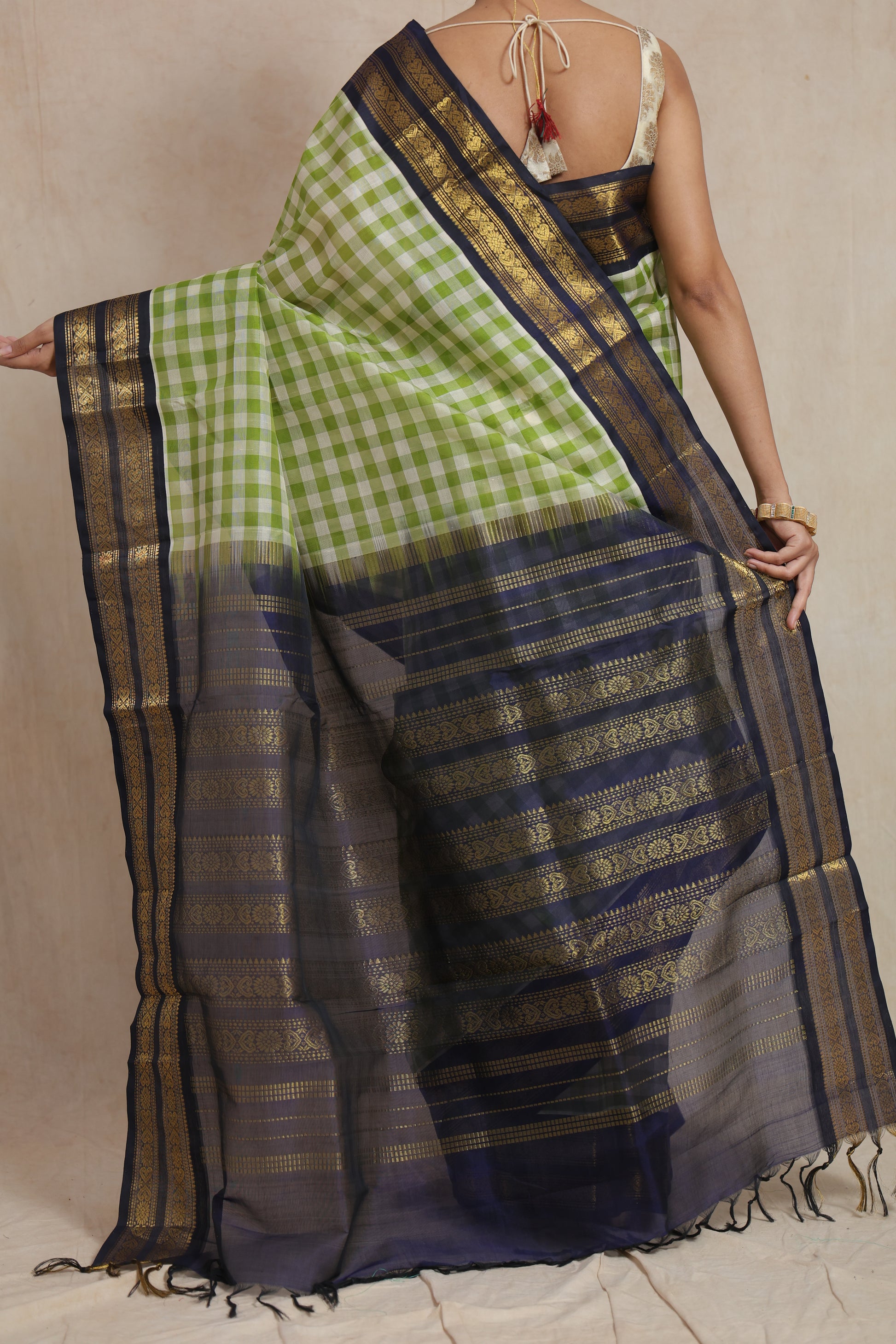 Detailed view of navy blue woven pallu on lime green checked Kanchipuram Sico saree