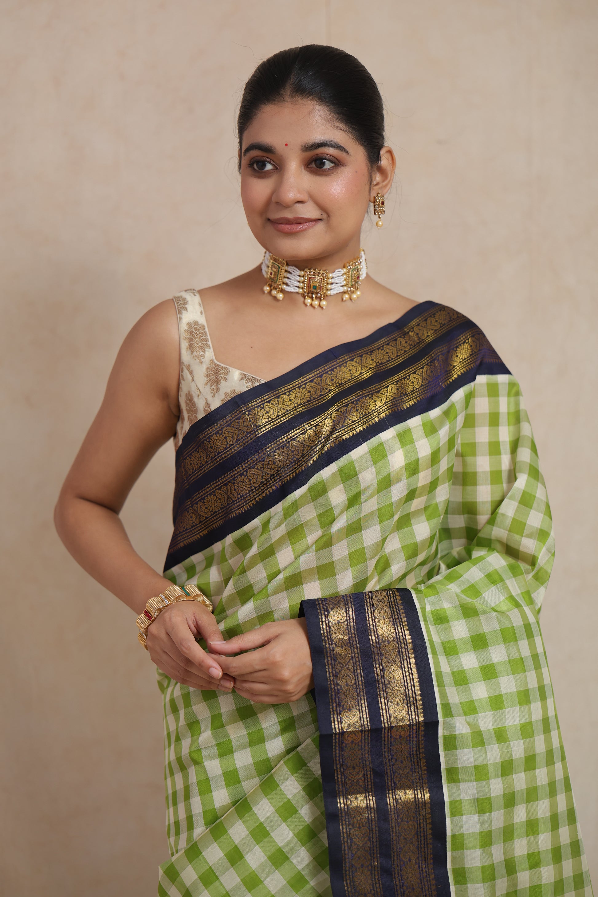 Portrait view of elegant lime green checked Kanchipuram Sico saree with navy blue border