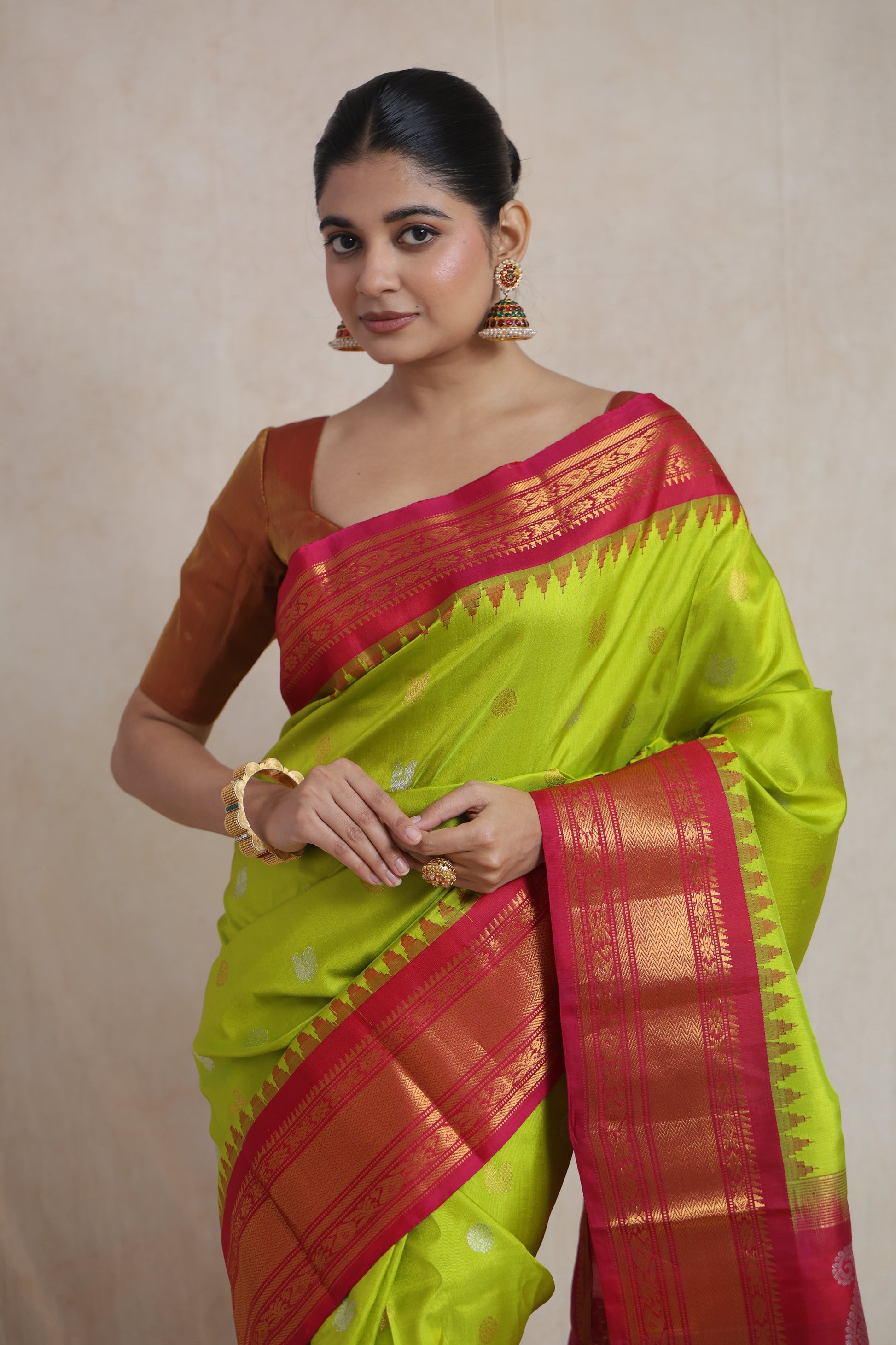Close-up of lime green Gadwal silk saree with zari woven border and motifs