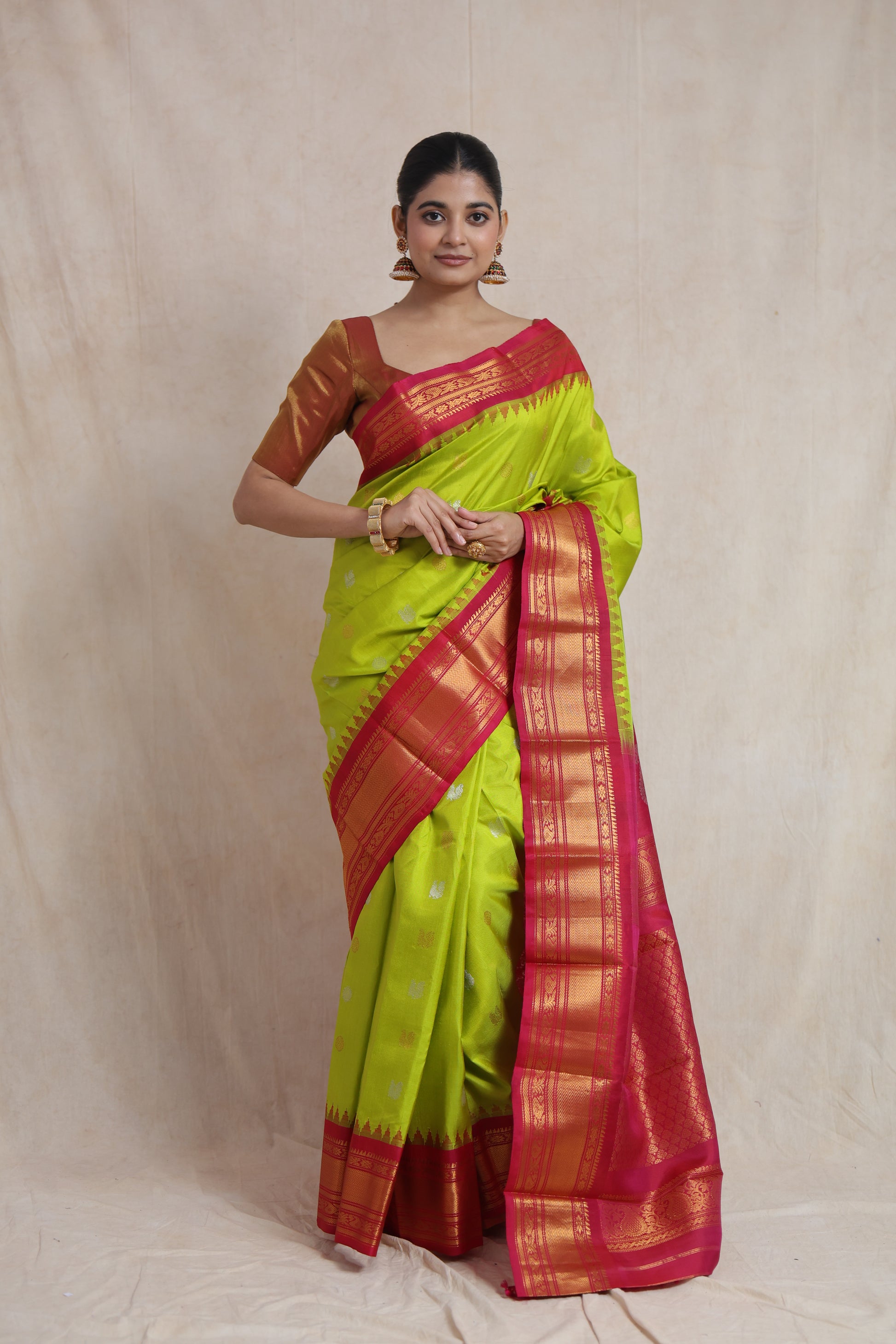 Front drape view of lime green Gadwal silk saree with woven buttas