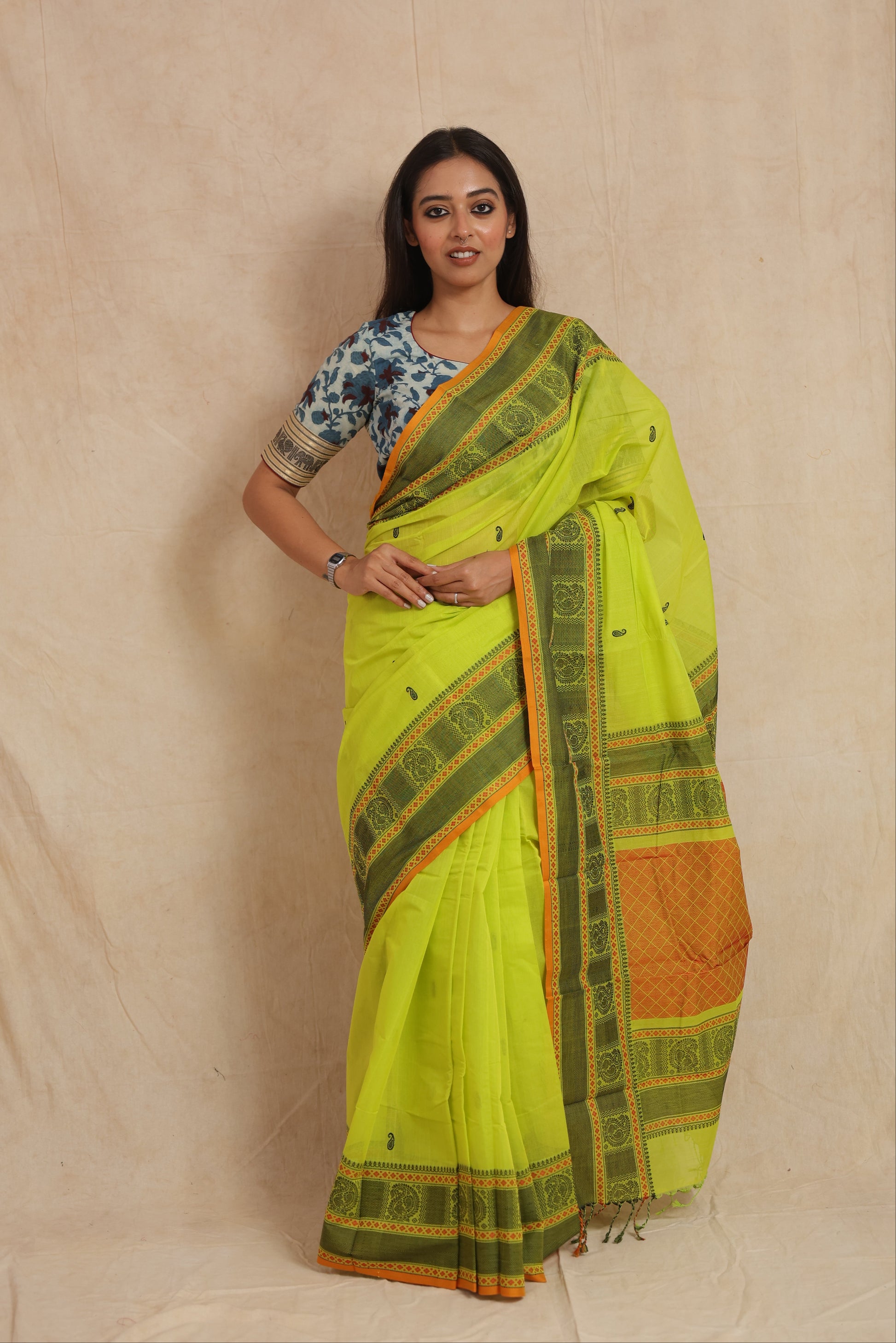 Front view of lime green Kanchipuram cotton saree with woven traditional border