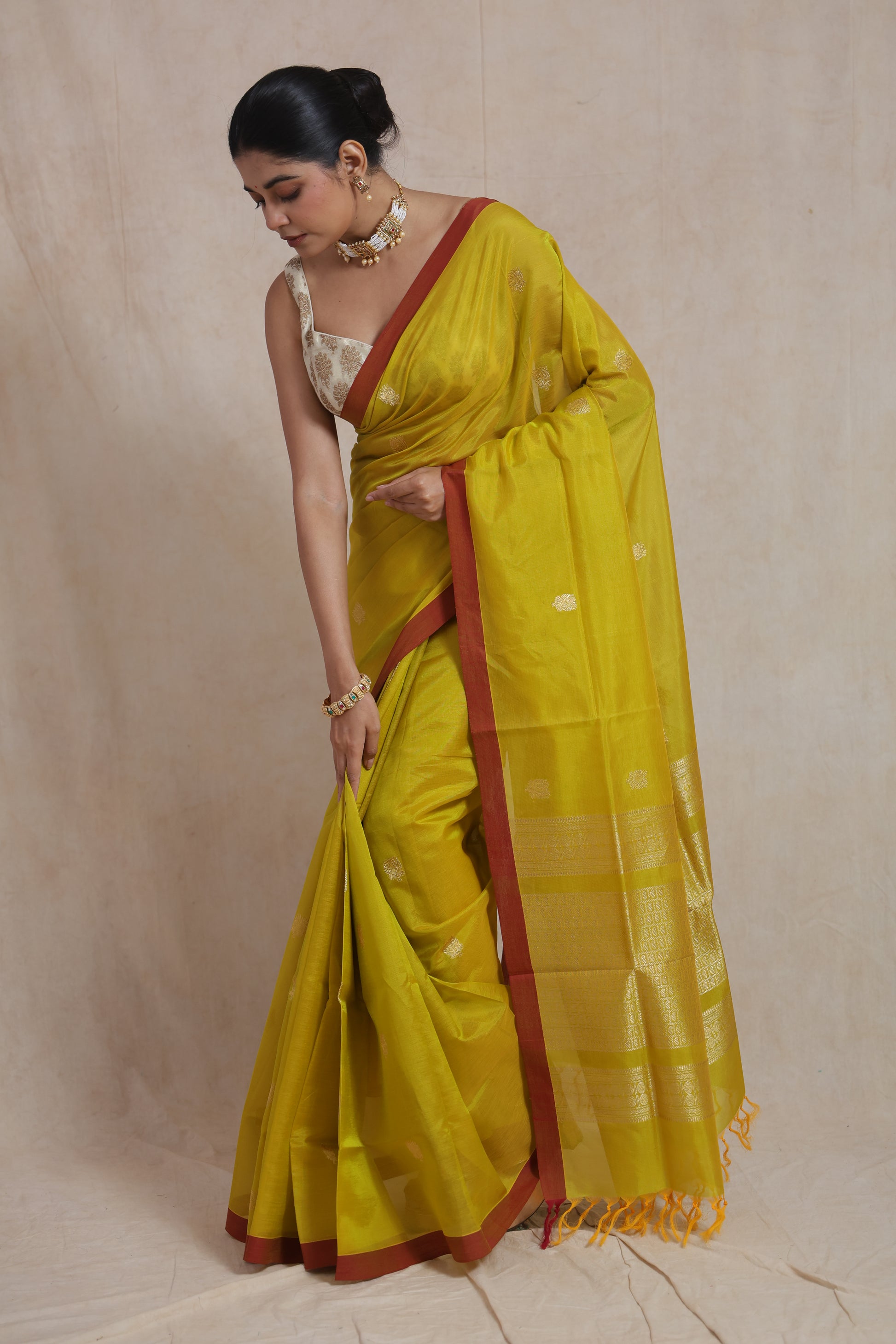 Graceful drape of lime yellow Kanchipuram Sico saree with woven zari pallu
