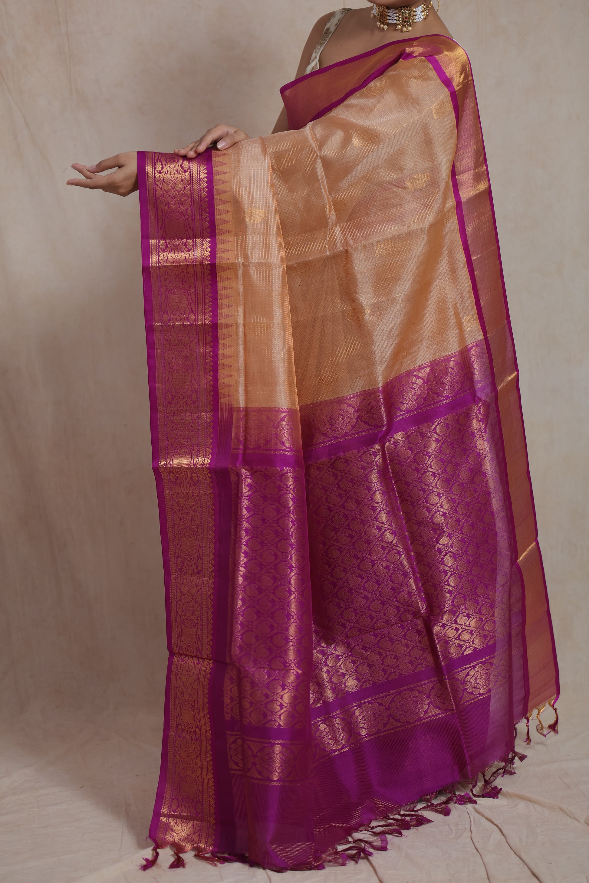 Detailed view of magenta zari woven border on golden beige Kanchipuram Sico saree