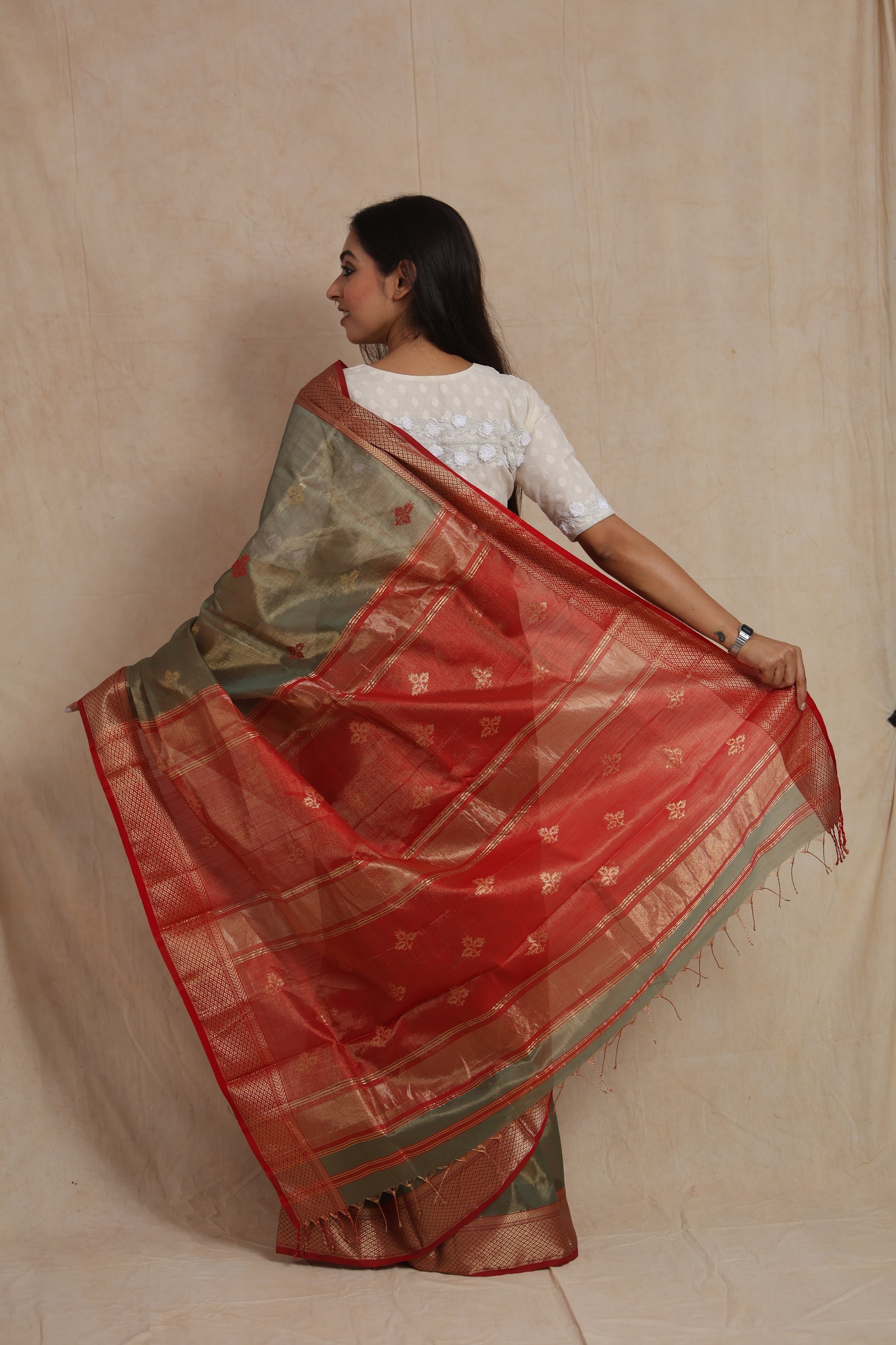 Back pallu view of olive green Maheshwari silk cotton saree with zari woven detailing