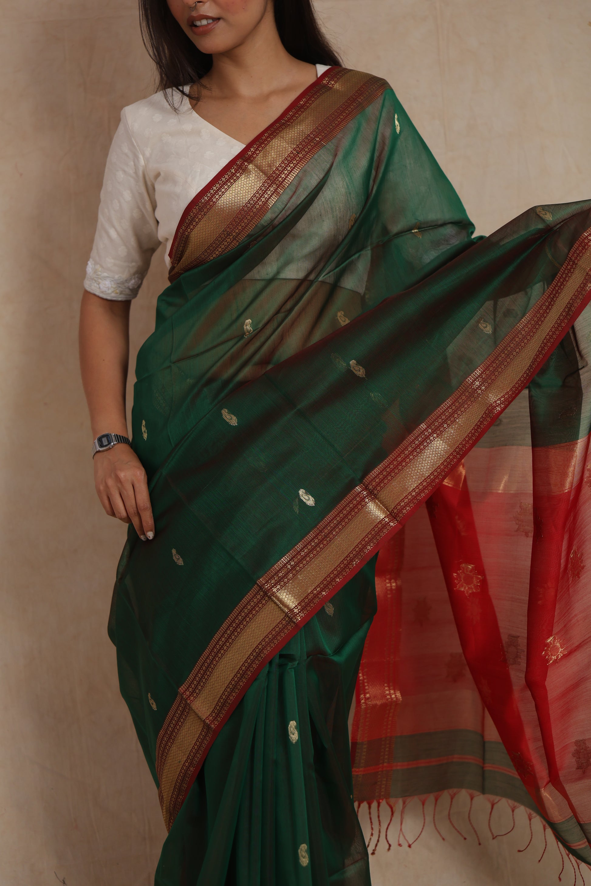 Close-up of bottle green Maheshwari silk cotton saree with delicate woven buttas and zari border
