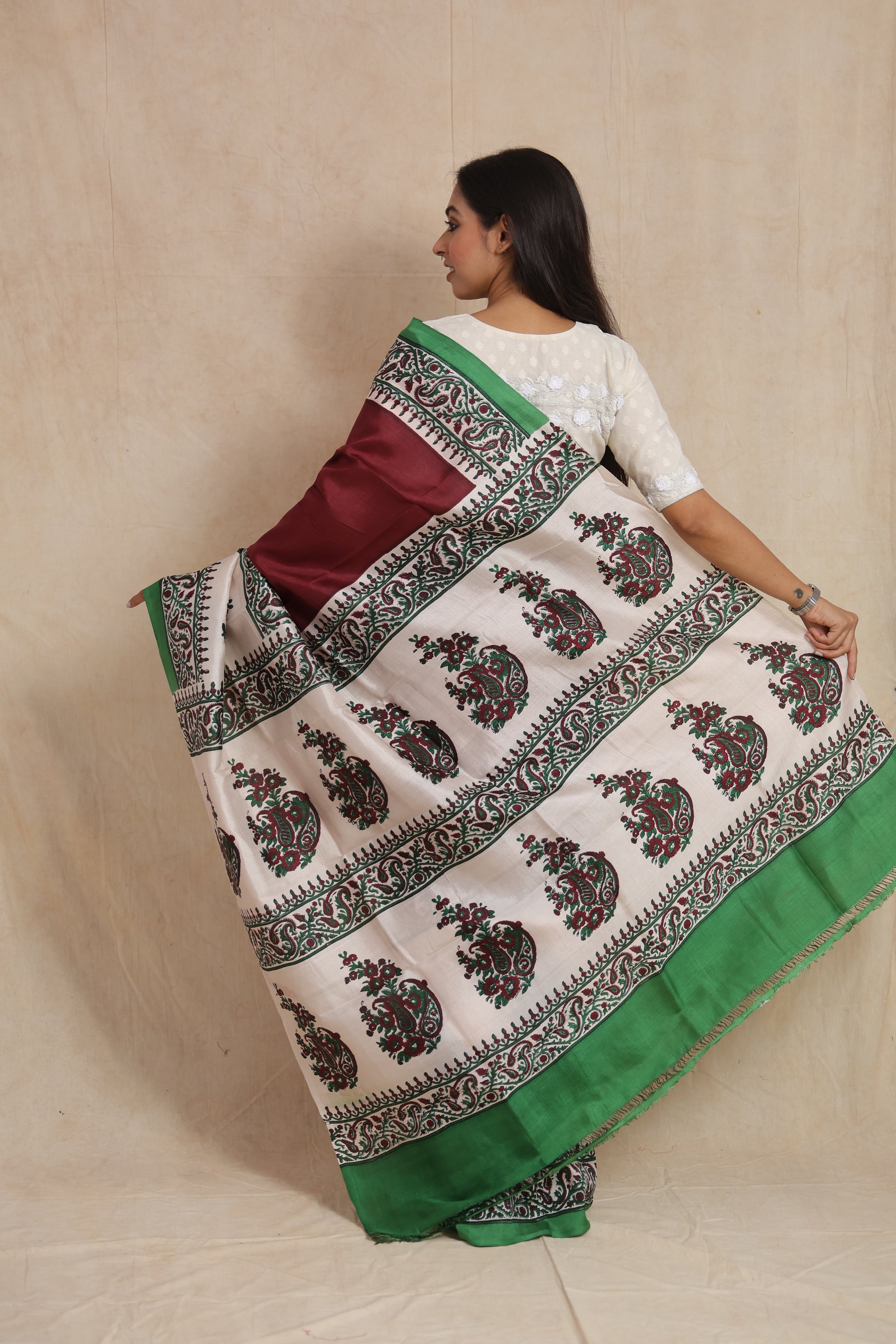 Back pallu view of maroon Batik silk saree showcasing detailed paisley motifs