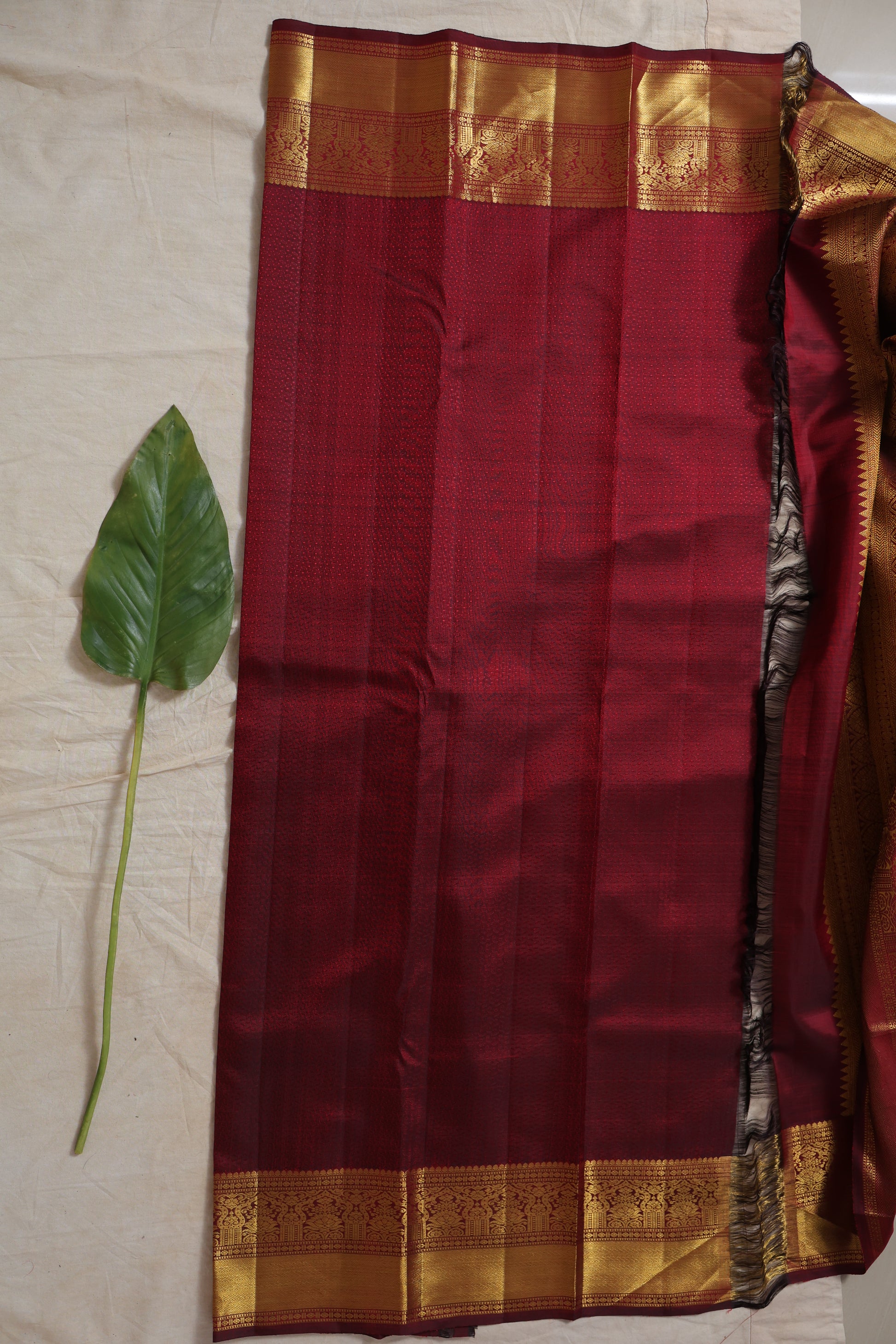 Body pattern detail of maroon Kanjivaram silk saree with subtle woven texture
