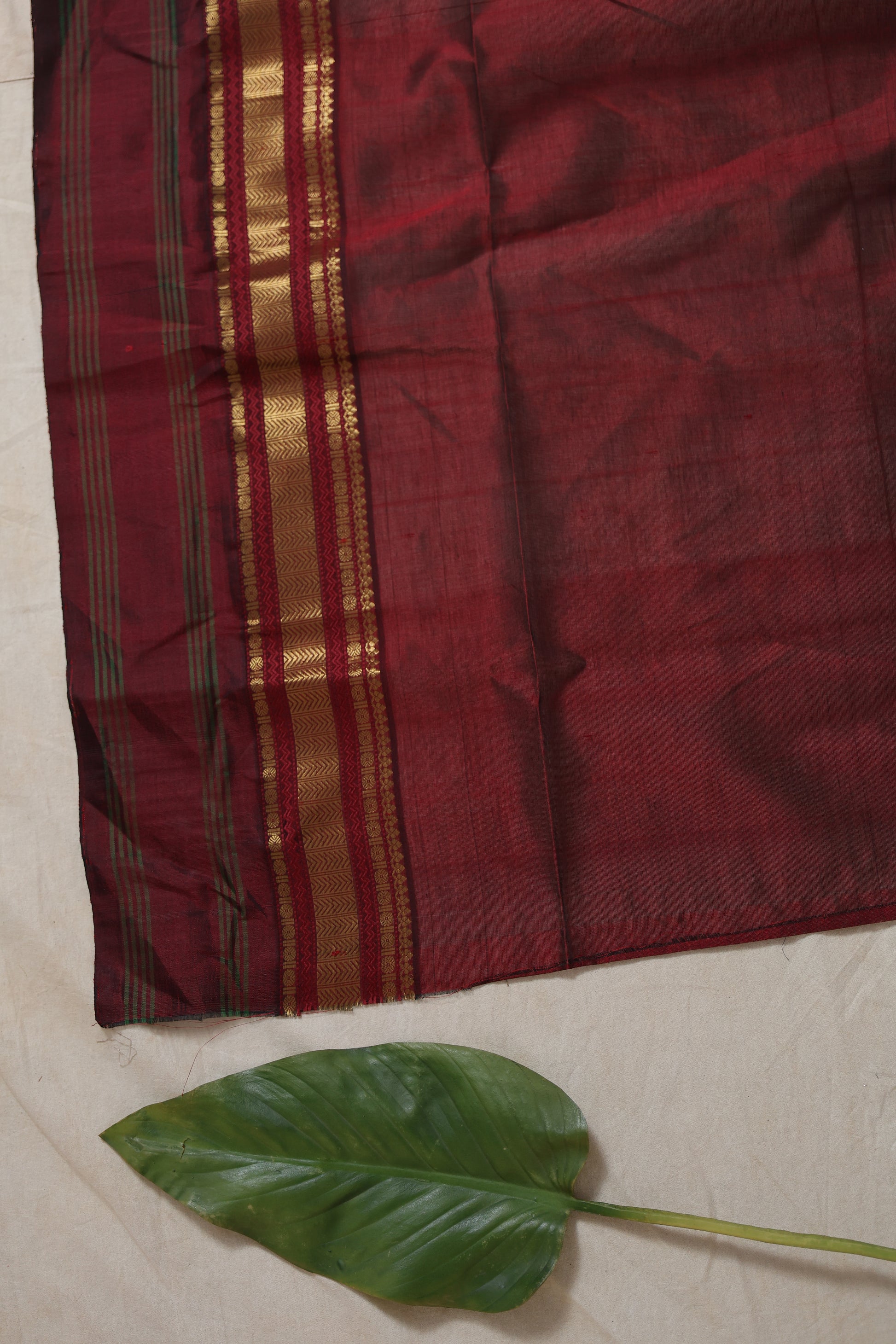 Maroon and gold zari border detail on Kanchipuram silk cotton saree