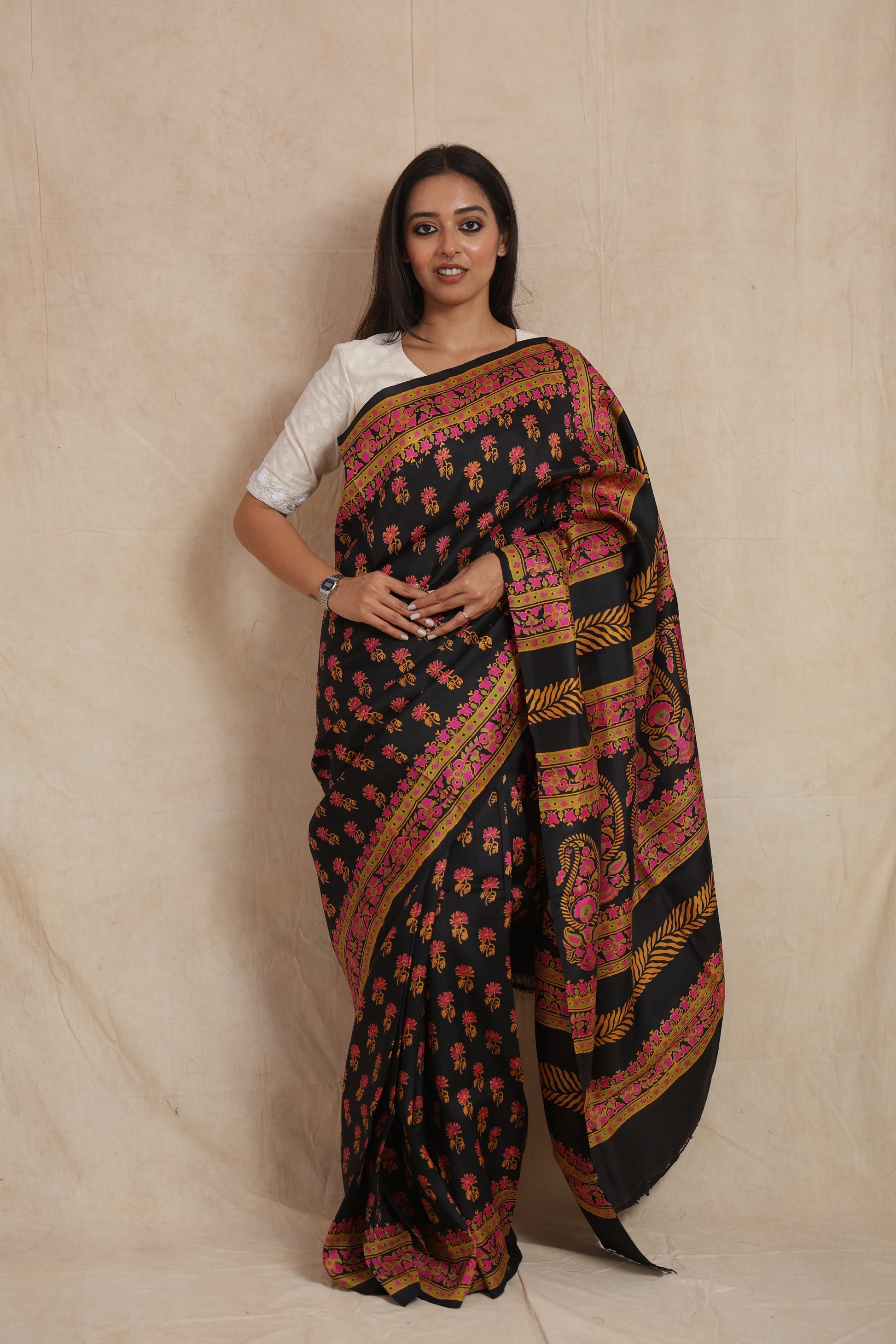 Front drape view of black Batik silk saree with traditional floral motifs