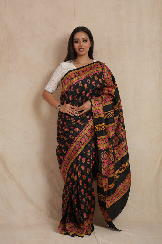 Front drape view of black Batik silk saree with traditional floral motifs