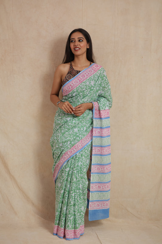 Model wearing mint green Sanghnaree cotton saree with floral print front view