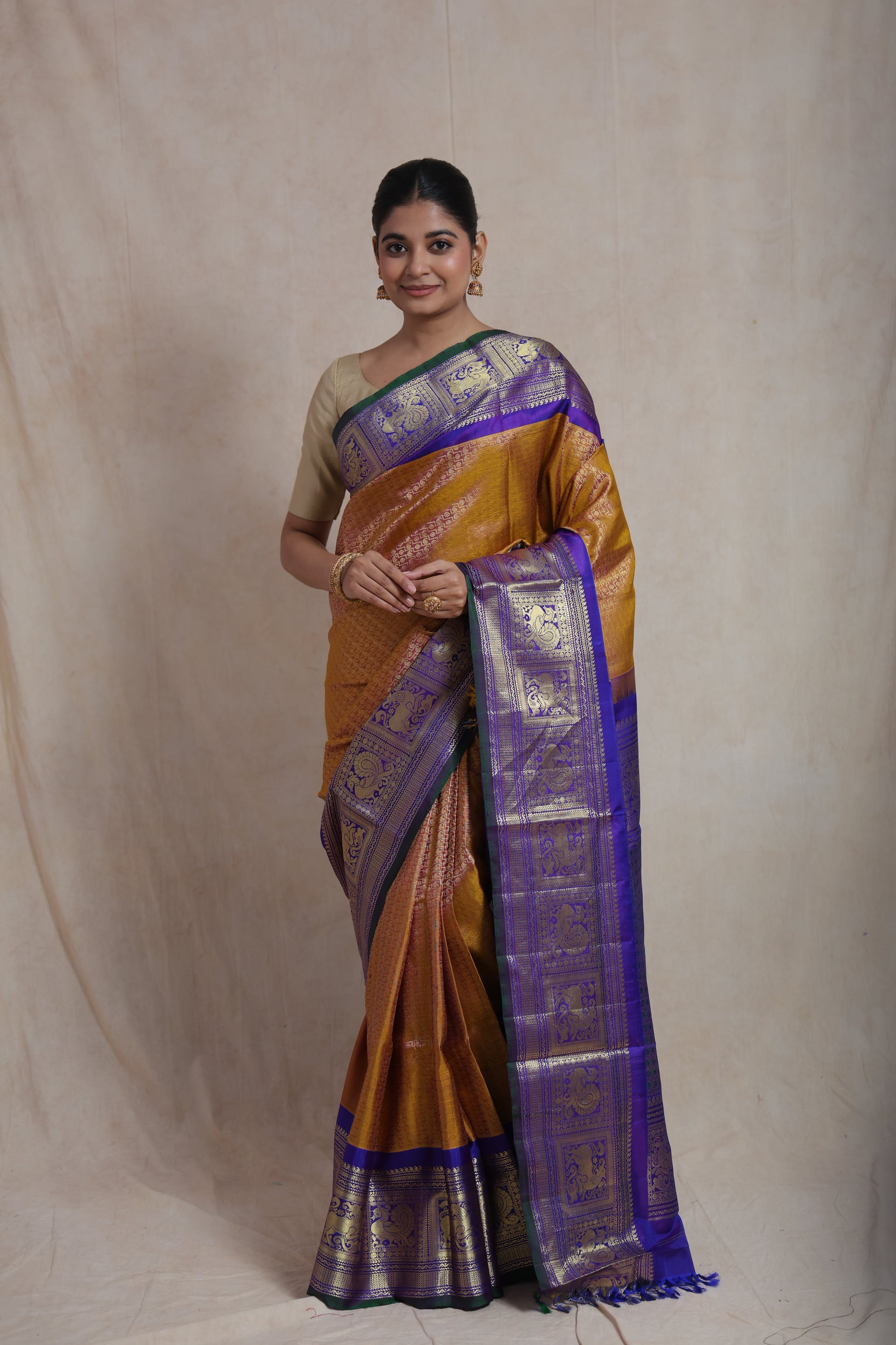 Elegant front look of mustard gold Gadwal Silk saree with purple zari pallu
