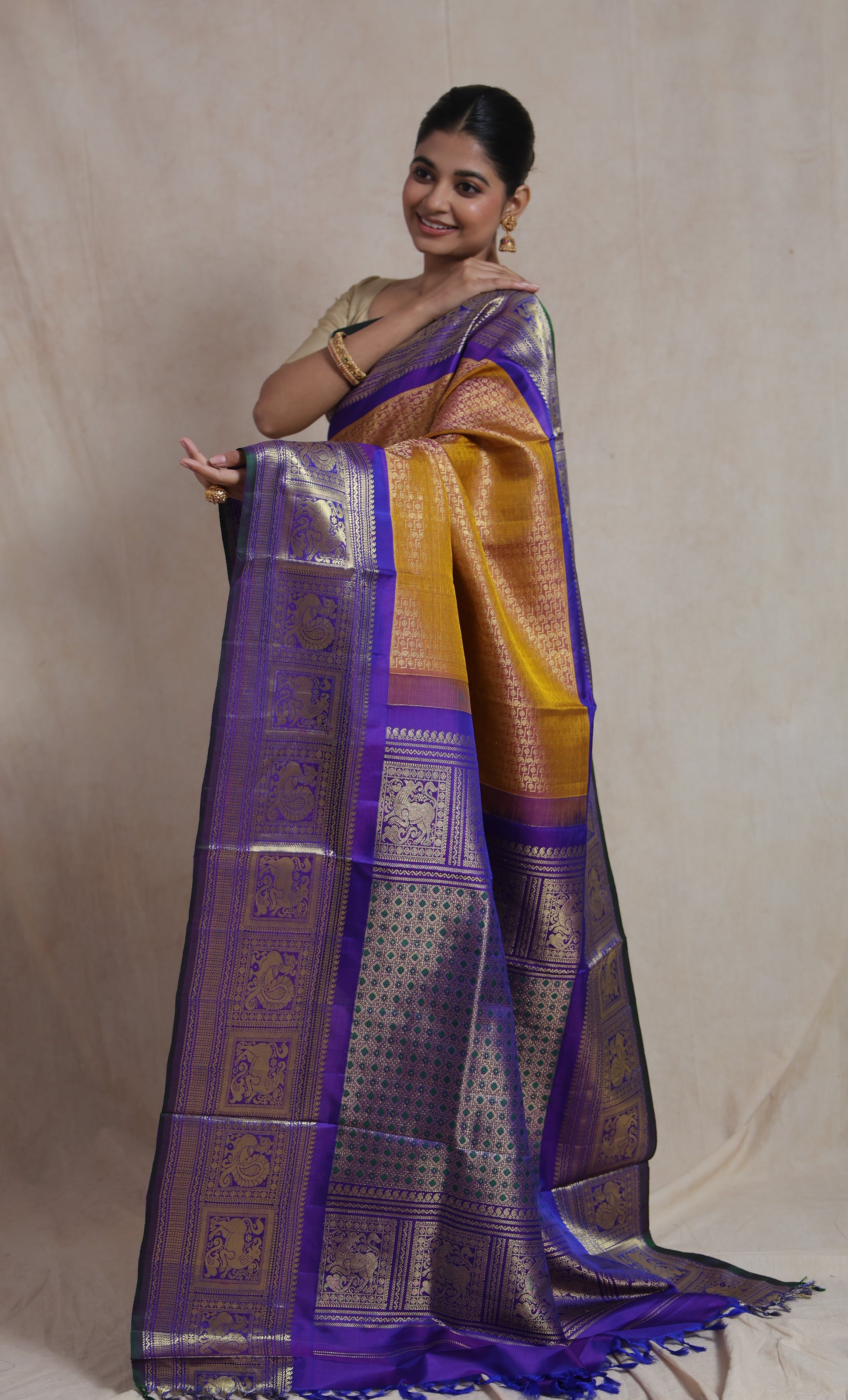 Full drape view of mustard gold Gadwal Silk saree with woven purple border