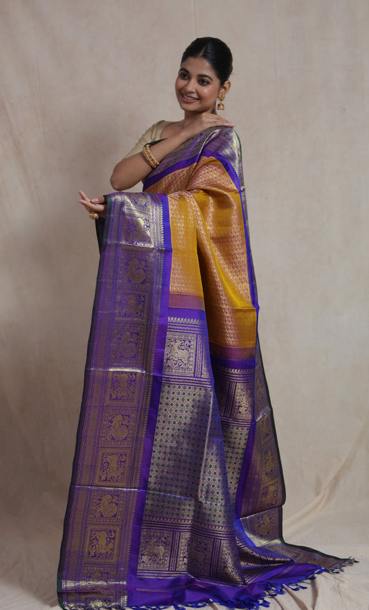 Full drape view of mustard gold Gadwal Silk saree with woven purple border
