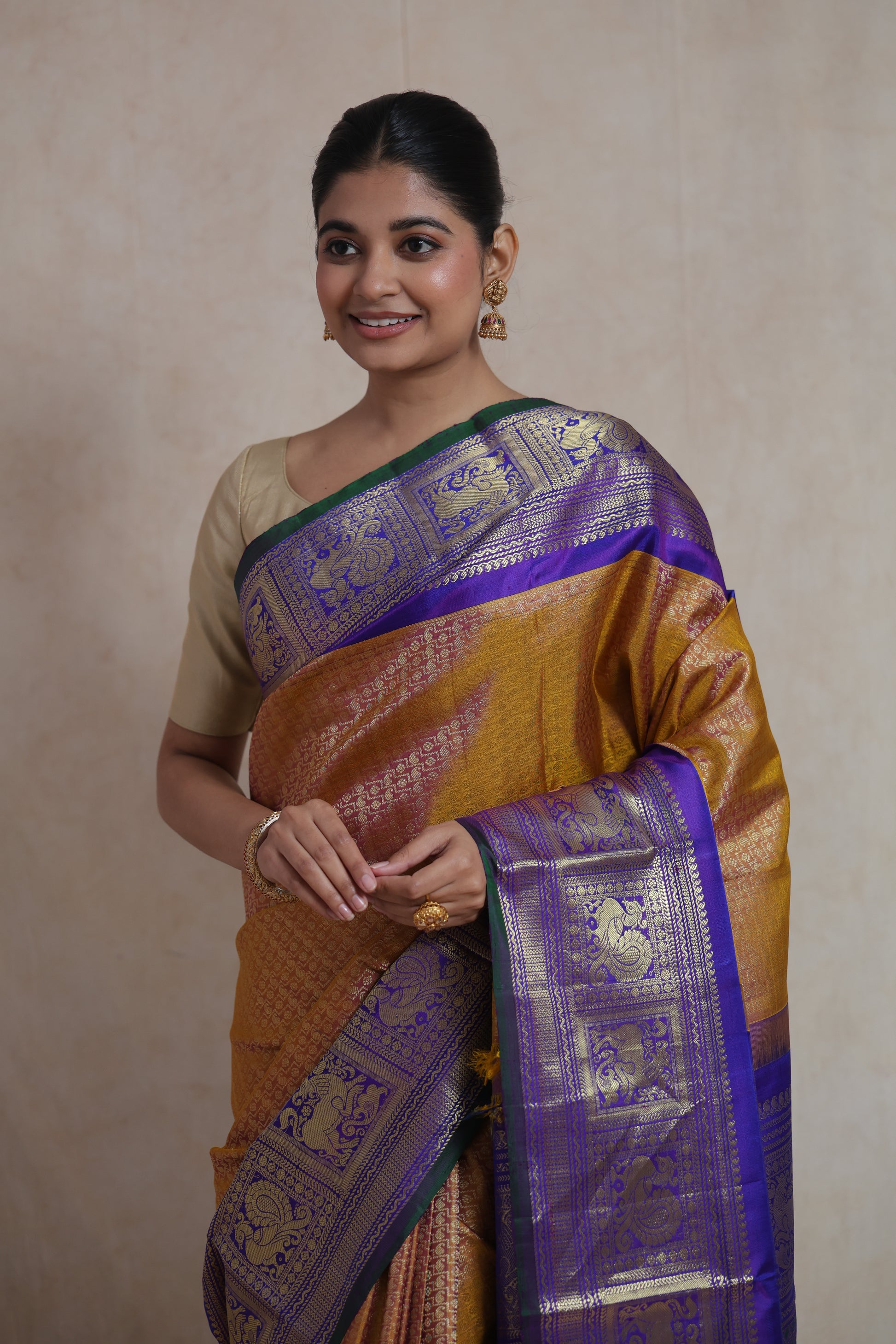 Portrait view of mustard gold Gadwal Silk saree with traditional zari detailing