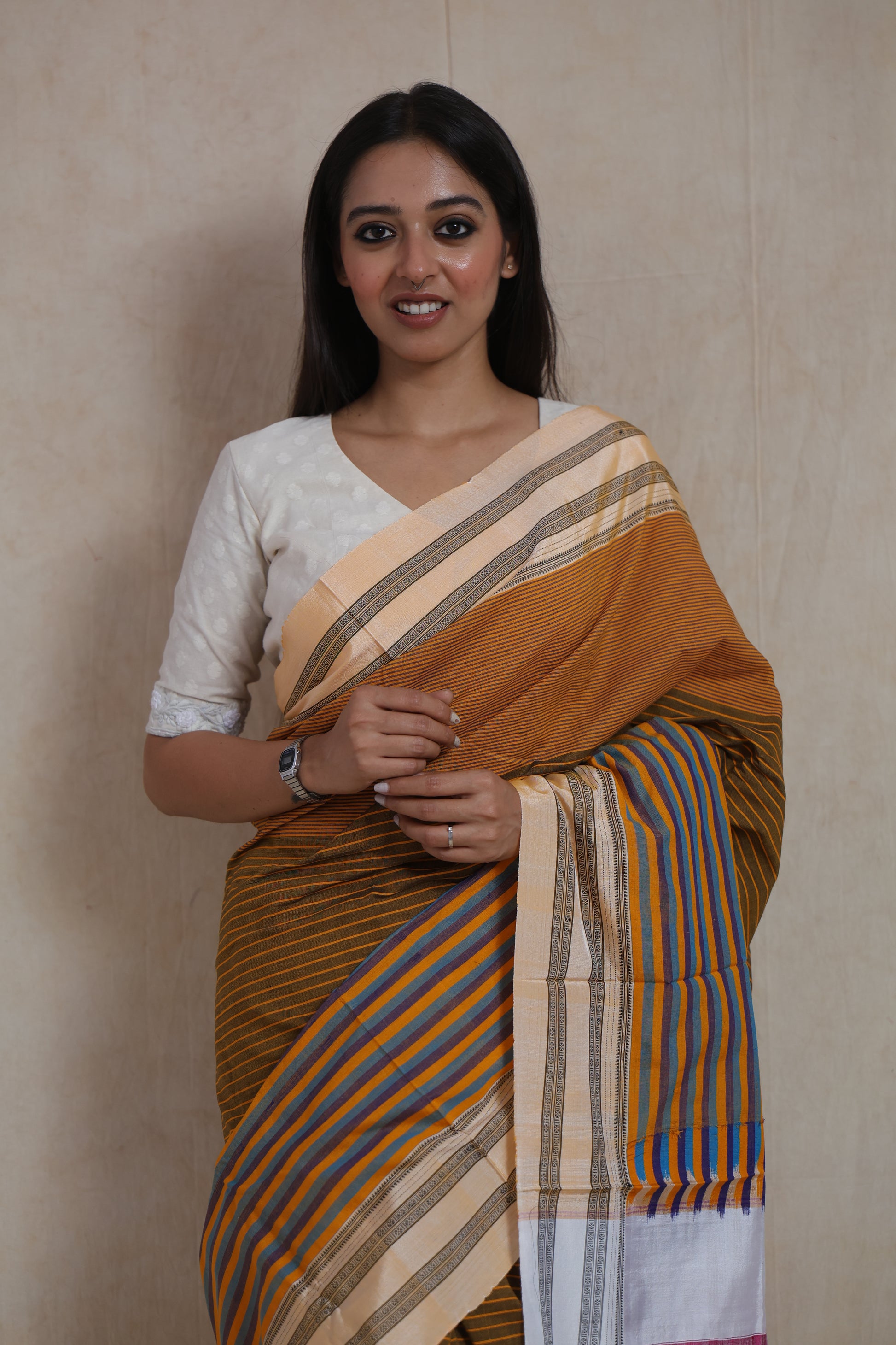 Close-up of Ilkal handloom cotton saree featuring pinstriped body, traditional border, and striped pallu detailing