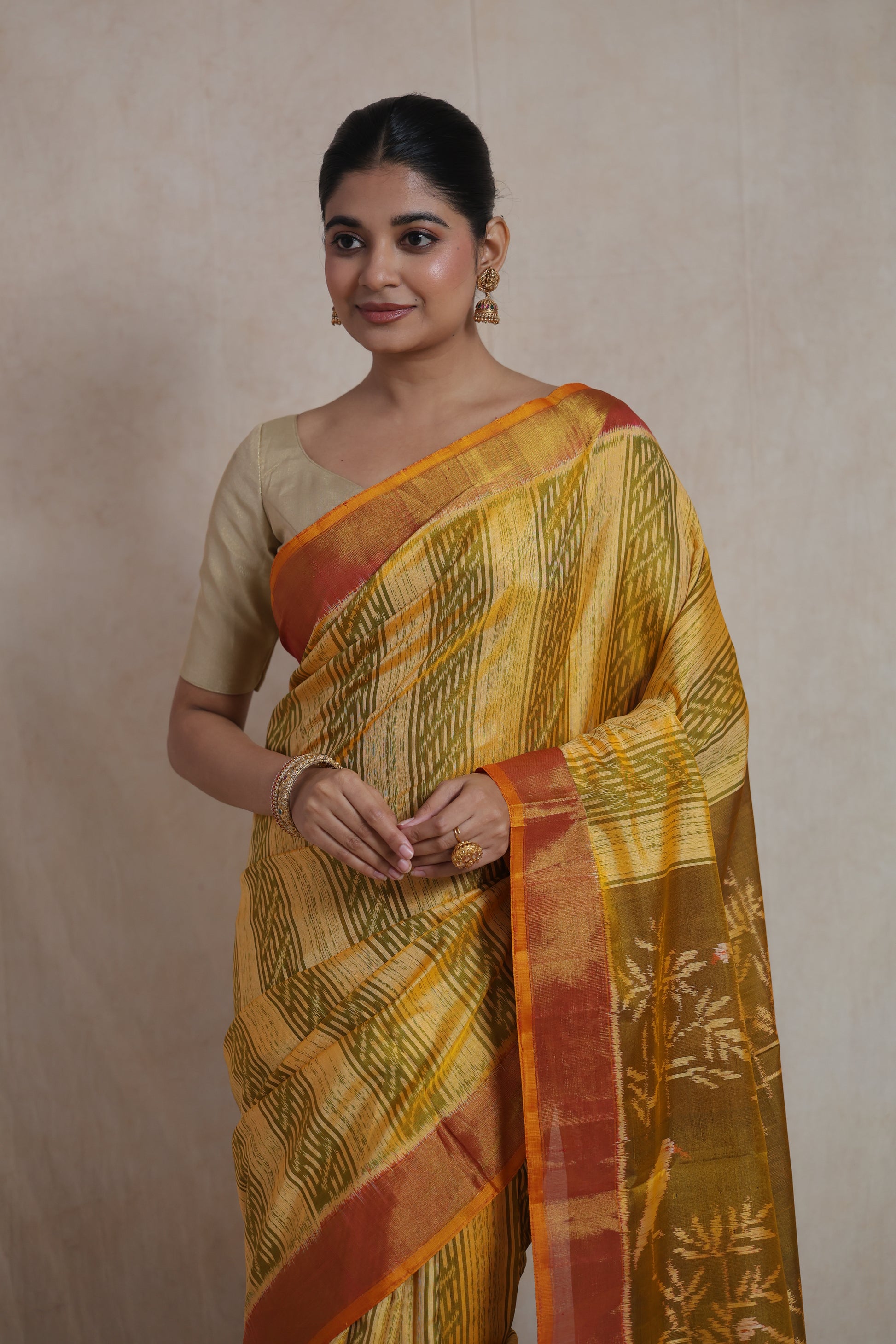 Front view of mustard yellow Patola silk saree with geometric woven patterns