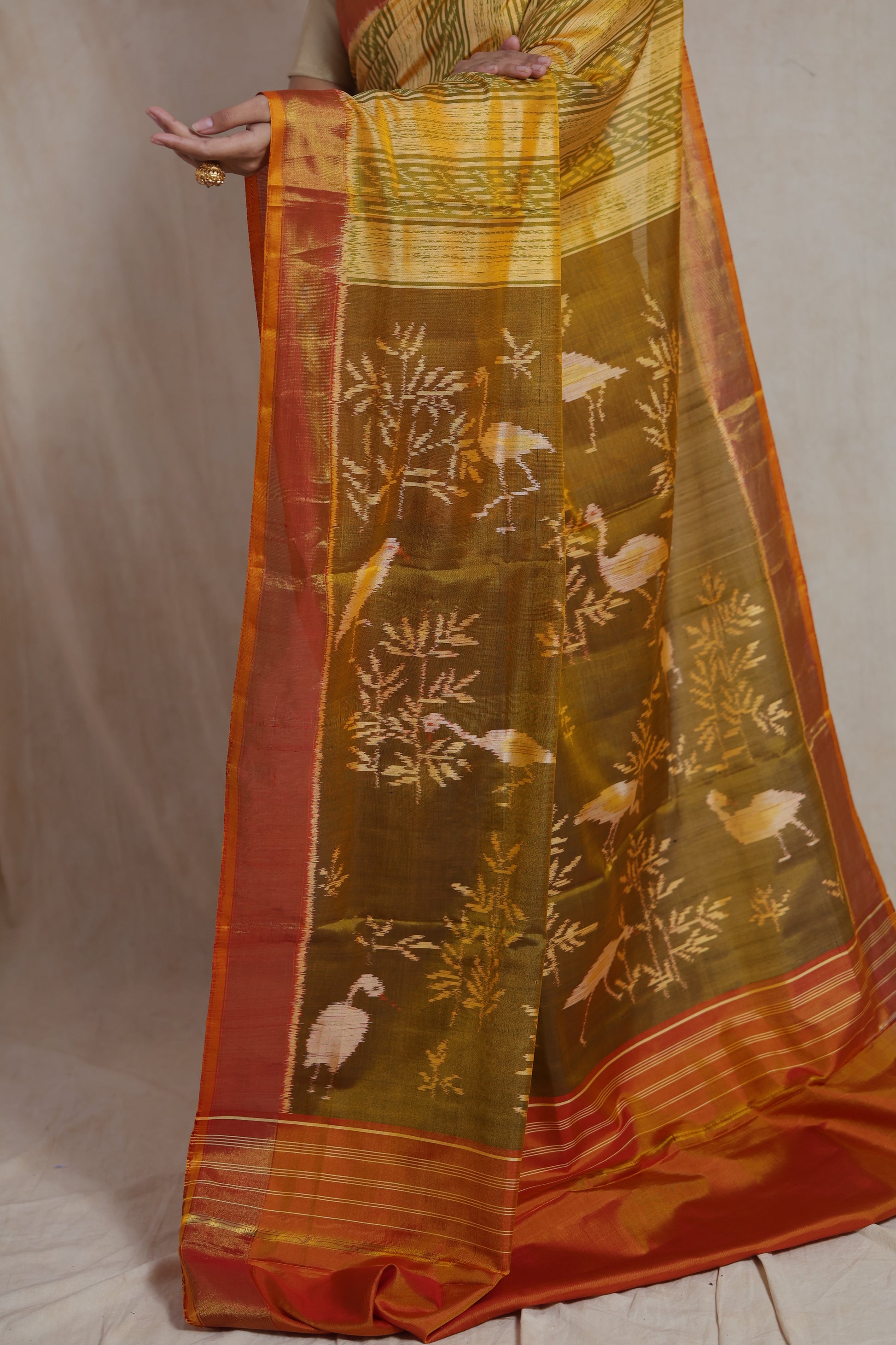 Detailed pallu view of mustard yellow Patola silk saree with bird motifs
