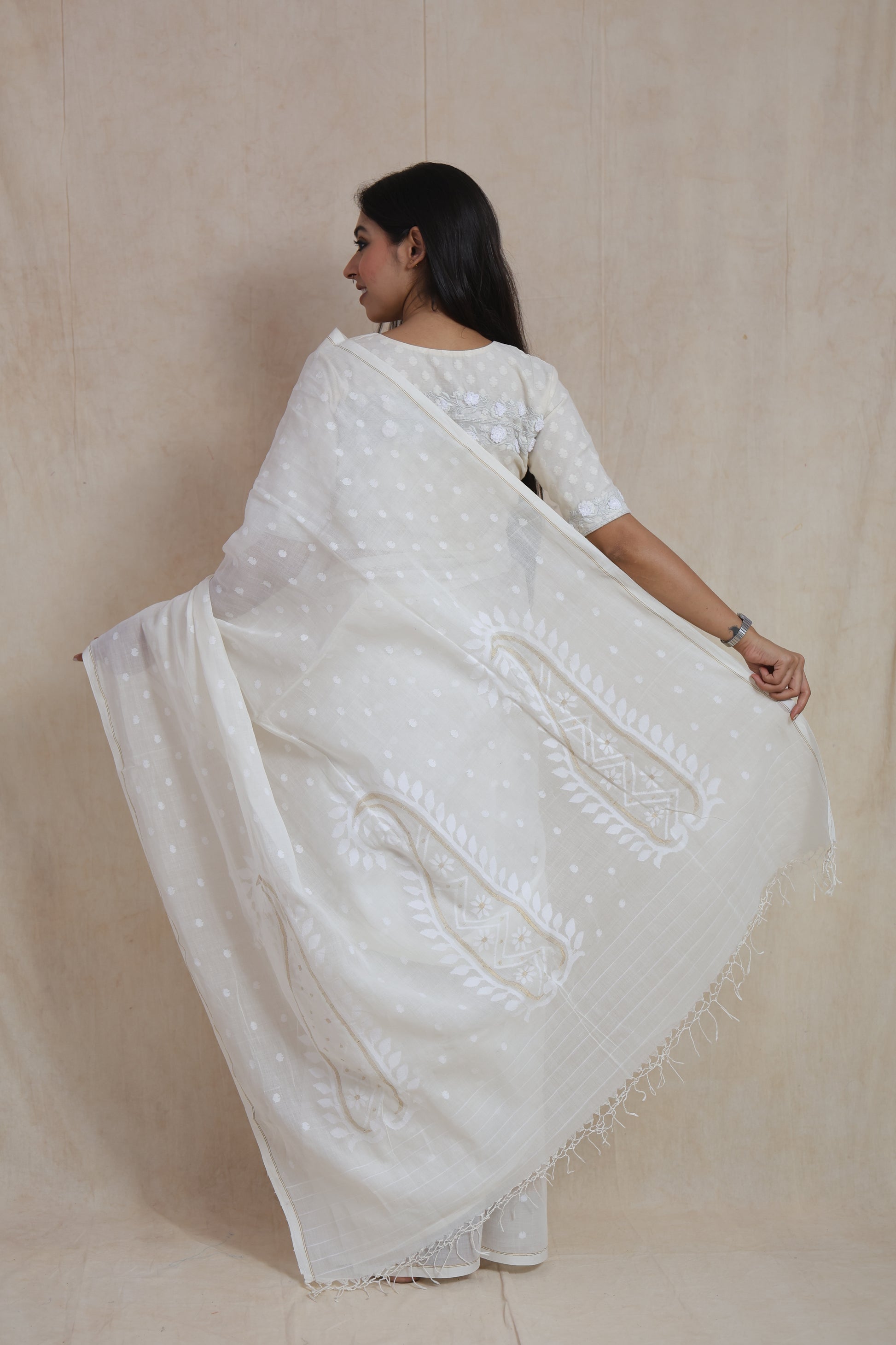 Front look of elegant off-white Bengal Fulia cotton saree with subtle butti weaving and soft drape