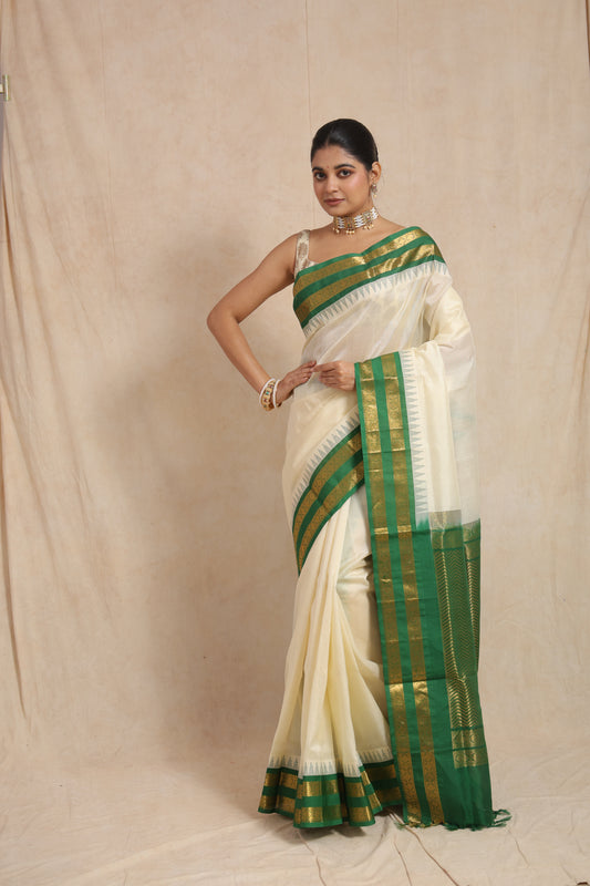 Full view of off-white Kanchipuram Sico saree with emerald green zari border
