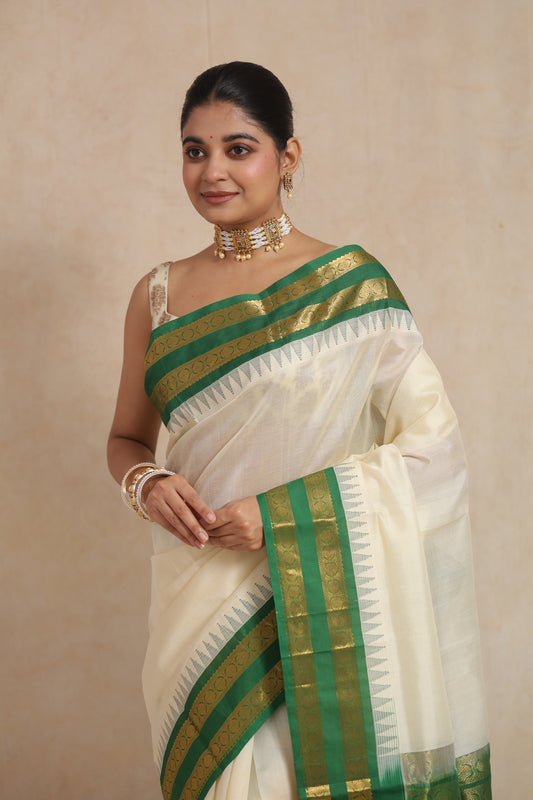 Portrait view of model wearing off-white Kanchipuram Sico saree with green border