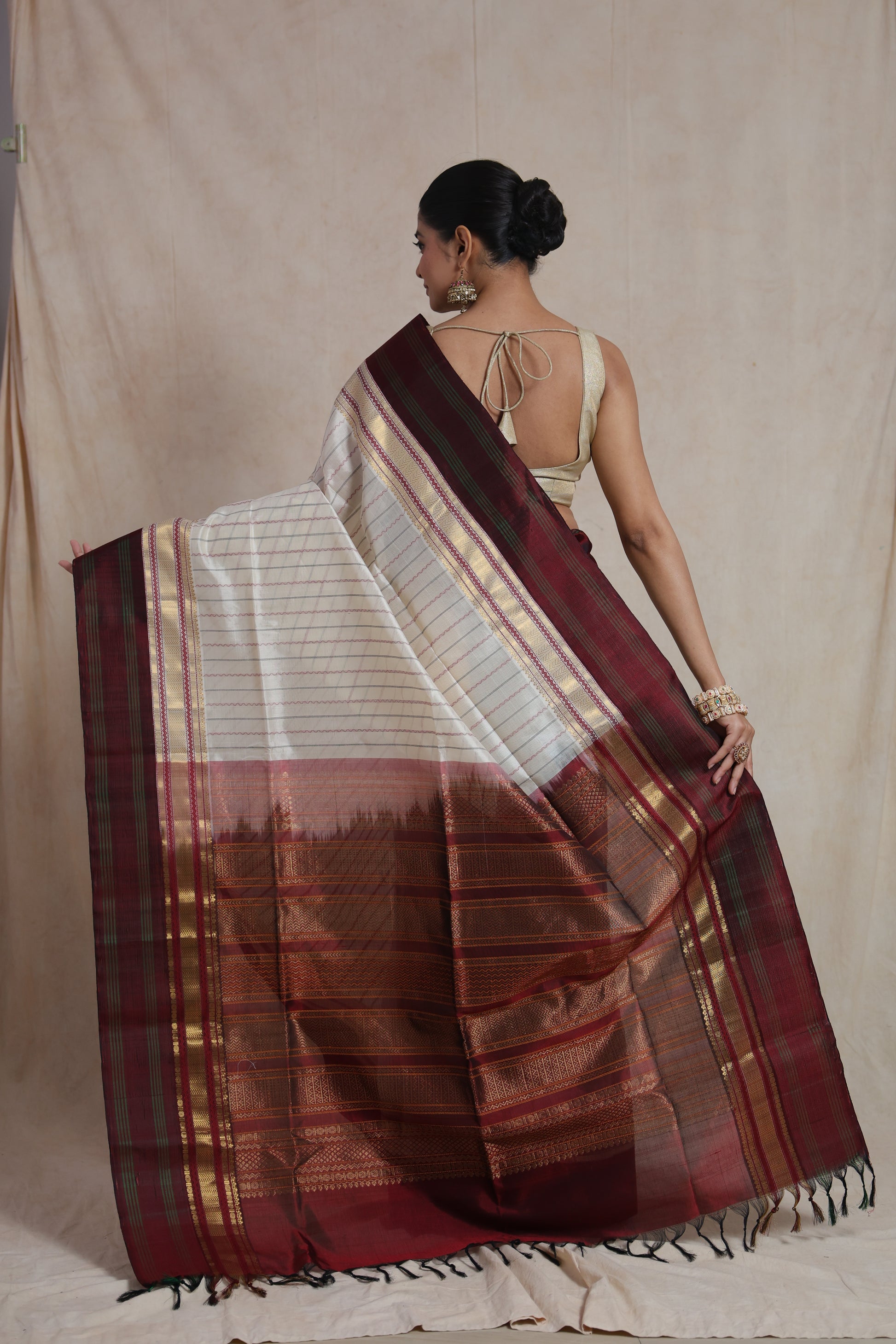 Back view of off white Kanchipuram silk cotton saree with maroon zari pallu