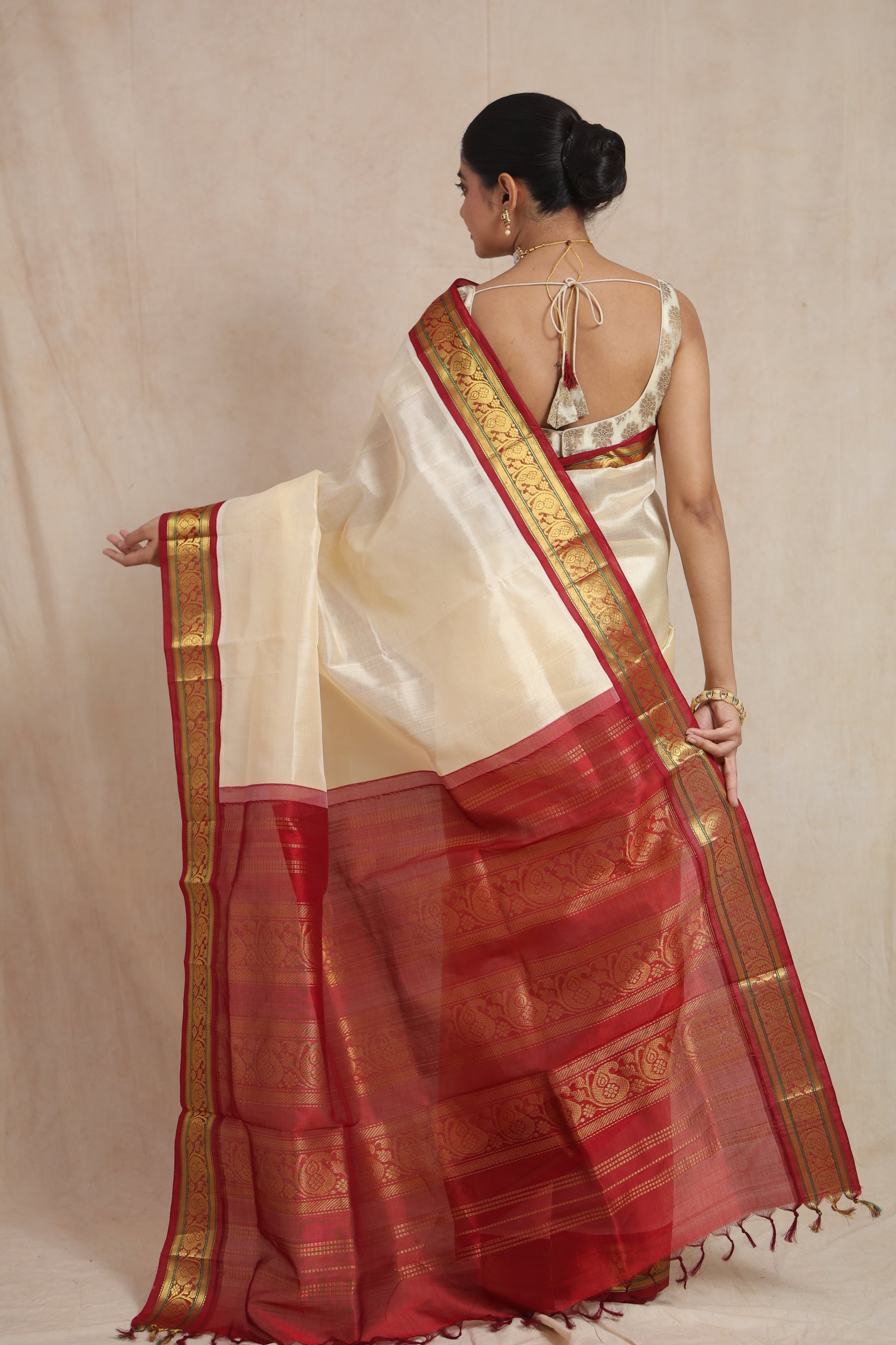 Back view of off-white Kanchipuram Sico saree with crimson red zari woven pallu