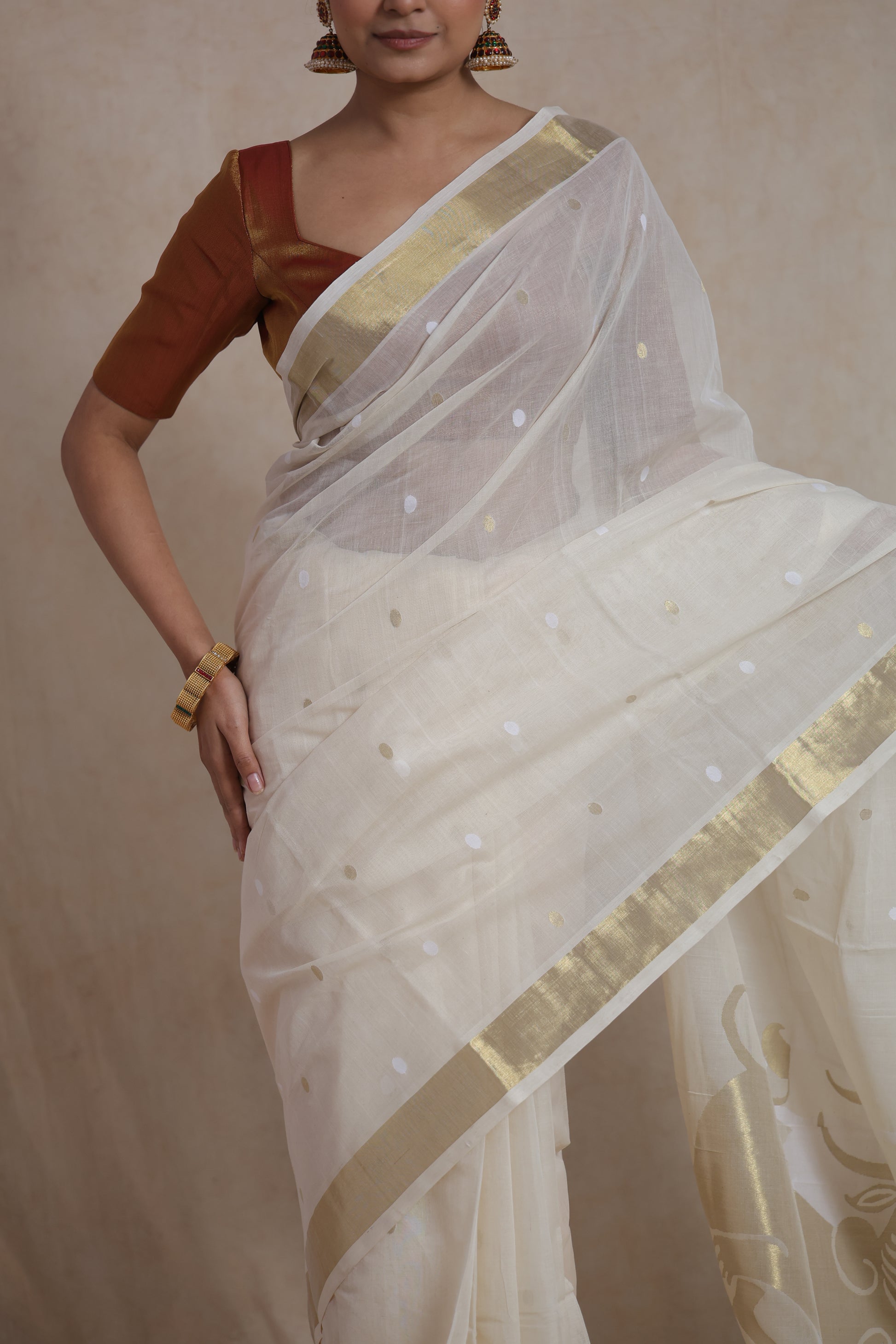 Detailed drape view of off white Kanchipuram cotton saree with woven buttas