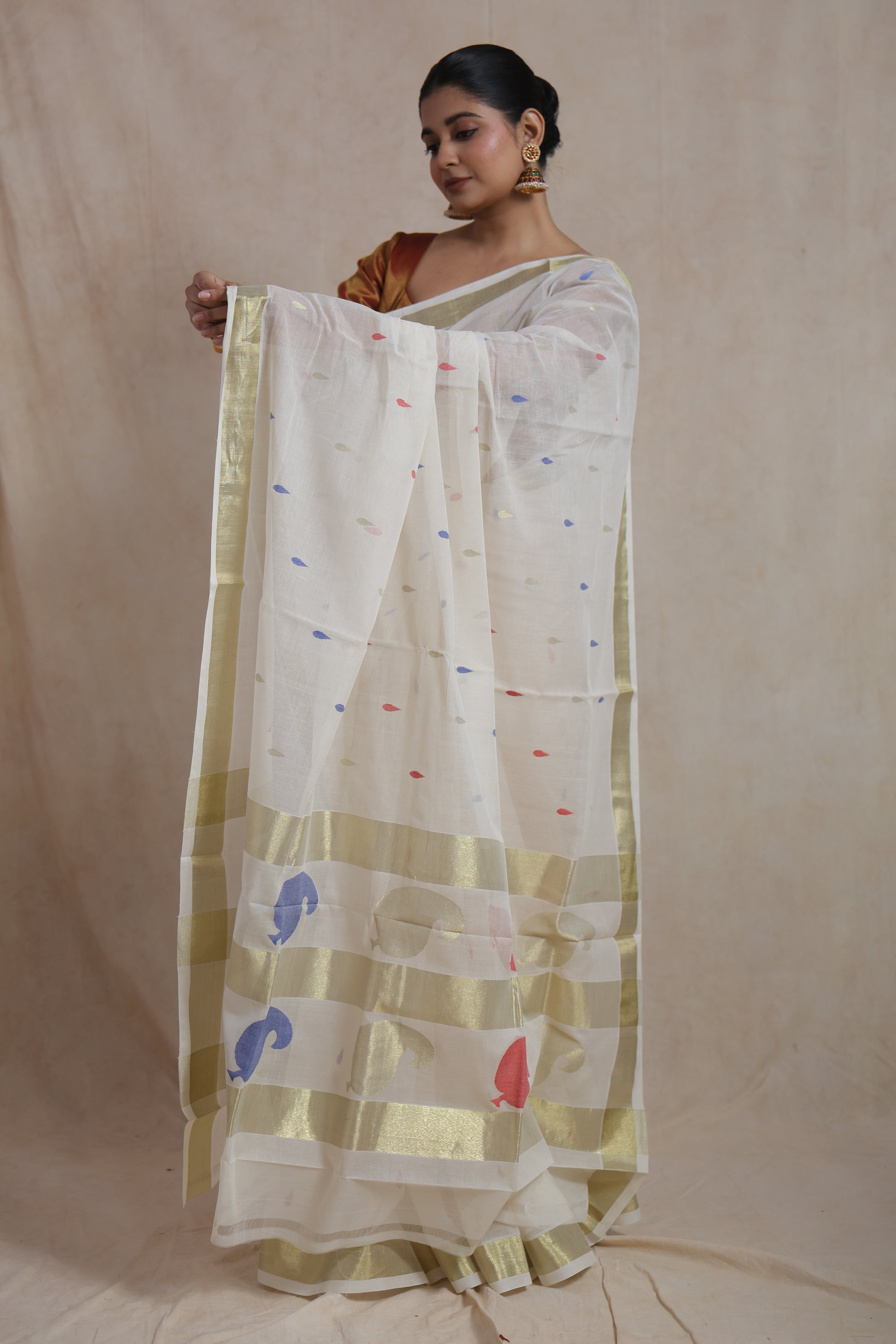 Full view of off white Kanchipuram cotton saree with colourful woven motifs
