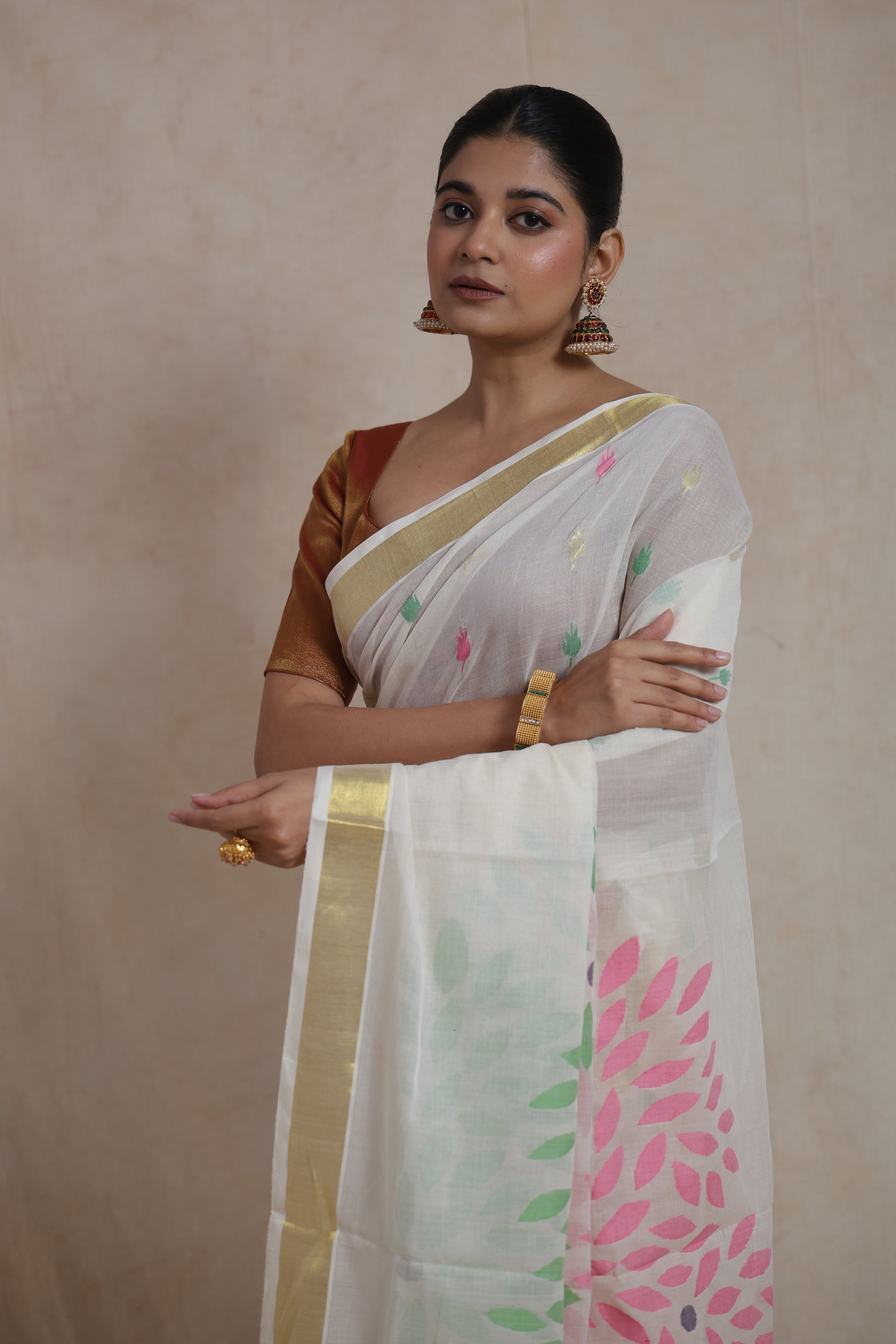 Close-up of multicolour woven buttas on off white Kanchipuram saree